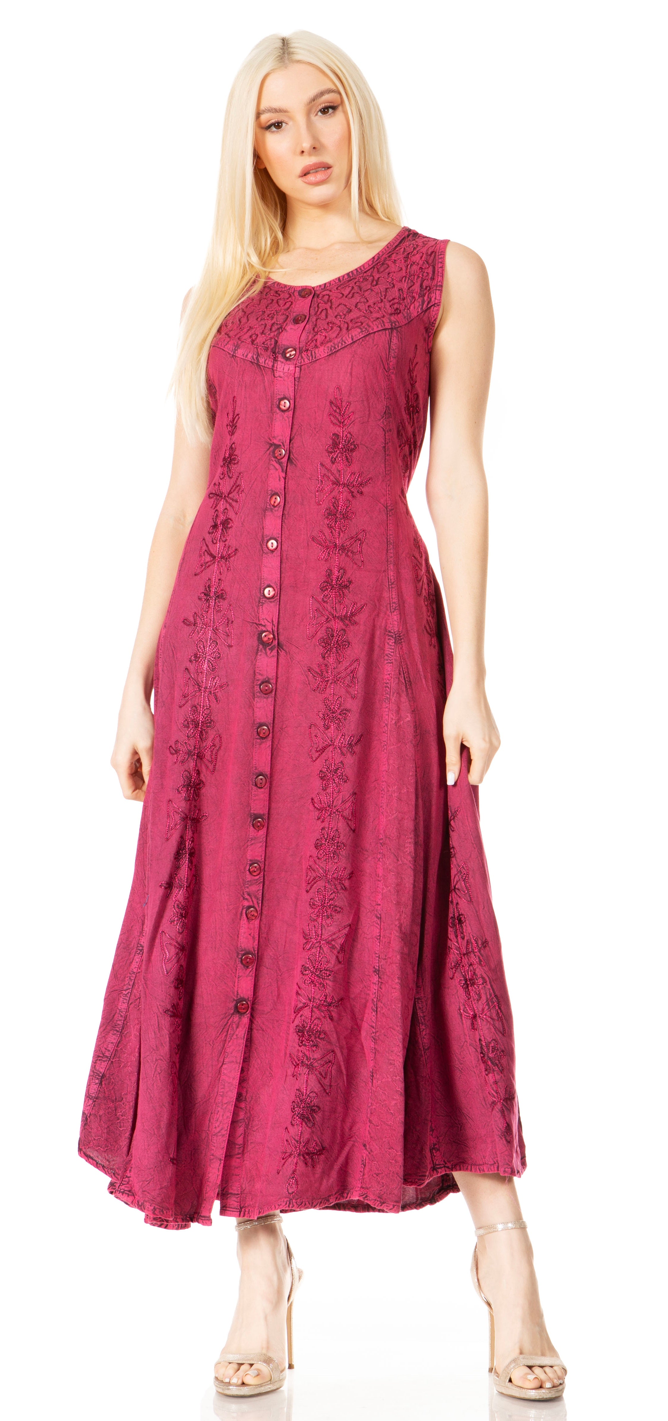 Woman wearing a pink sleeveless dress with a pattern on a white background