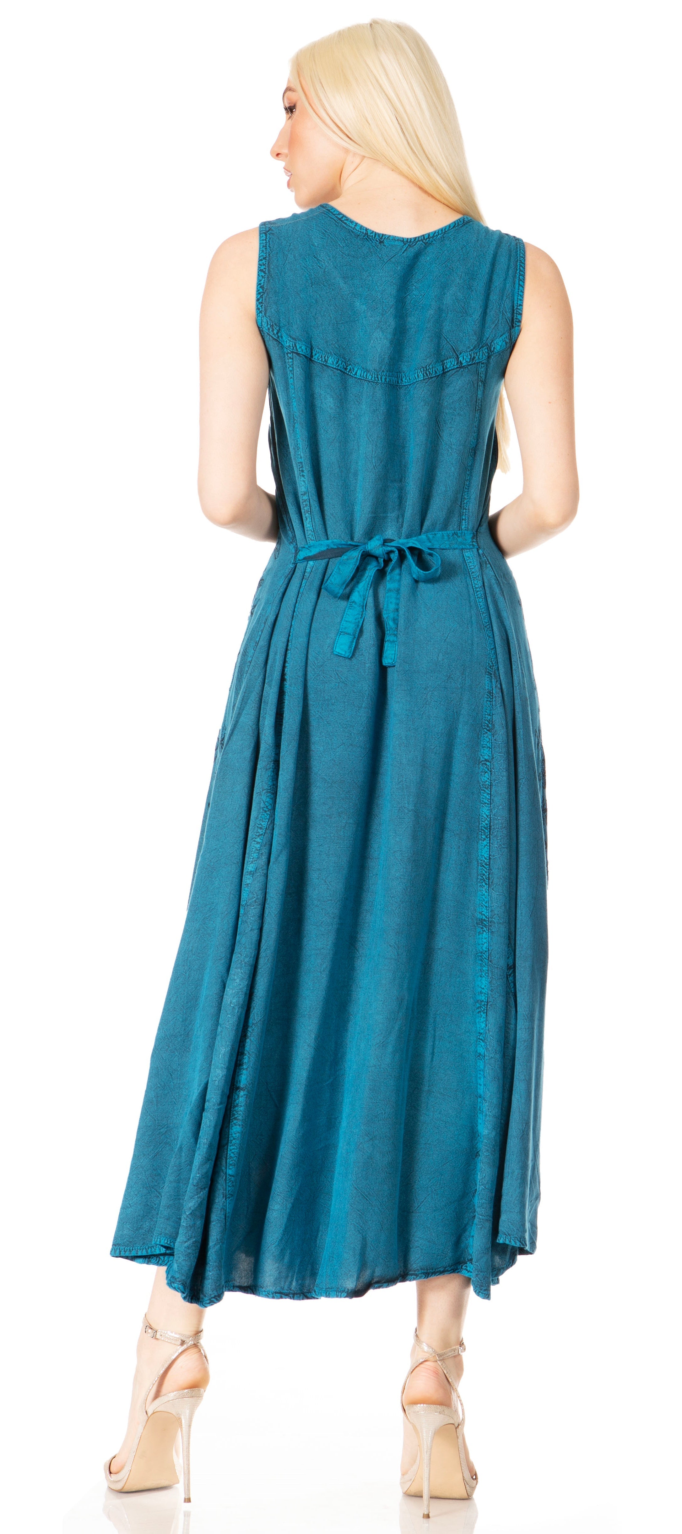 Woman wearing a teal dress with a belt on a white background