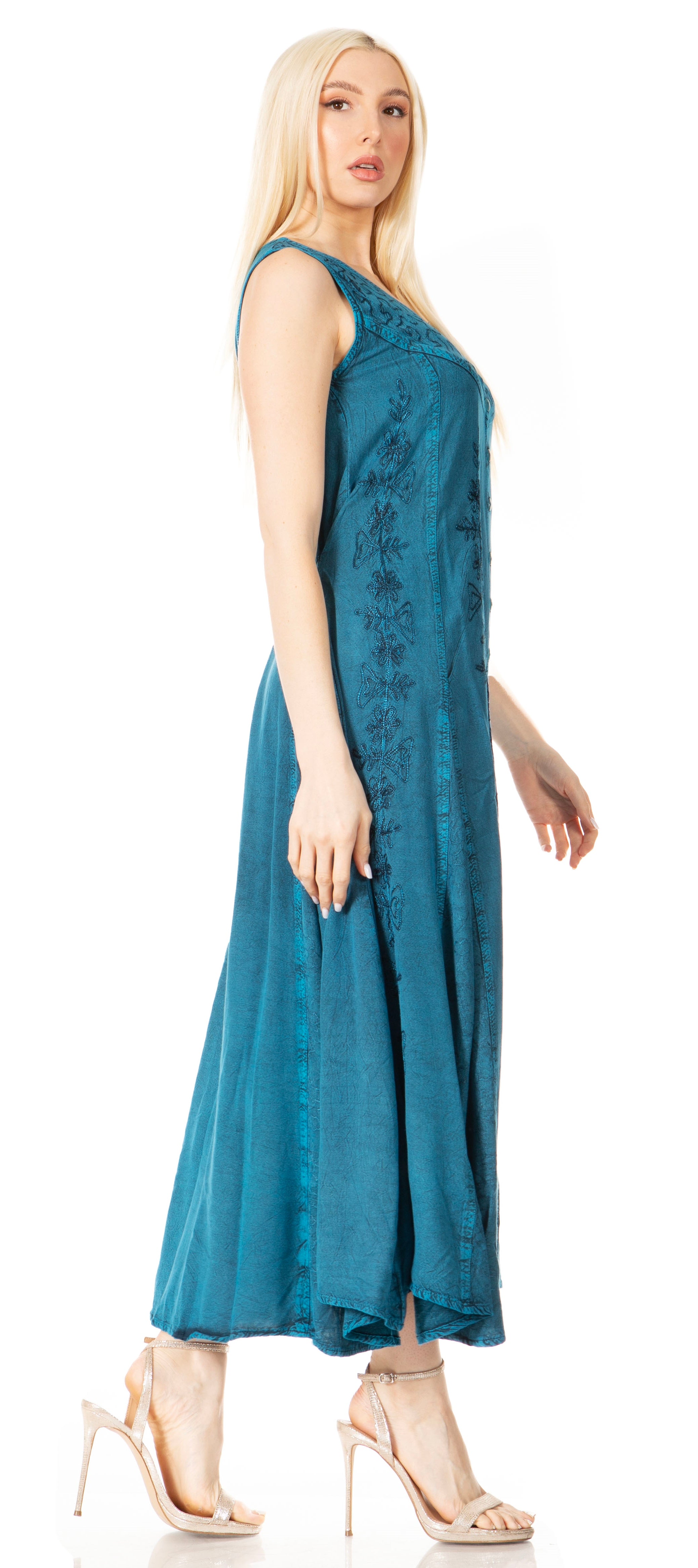 Woman wearing a blue dress with floral embroidery on a white background