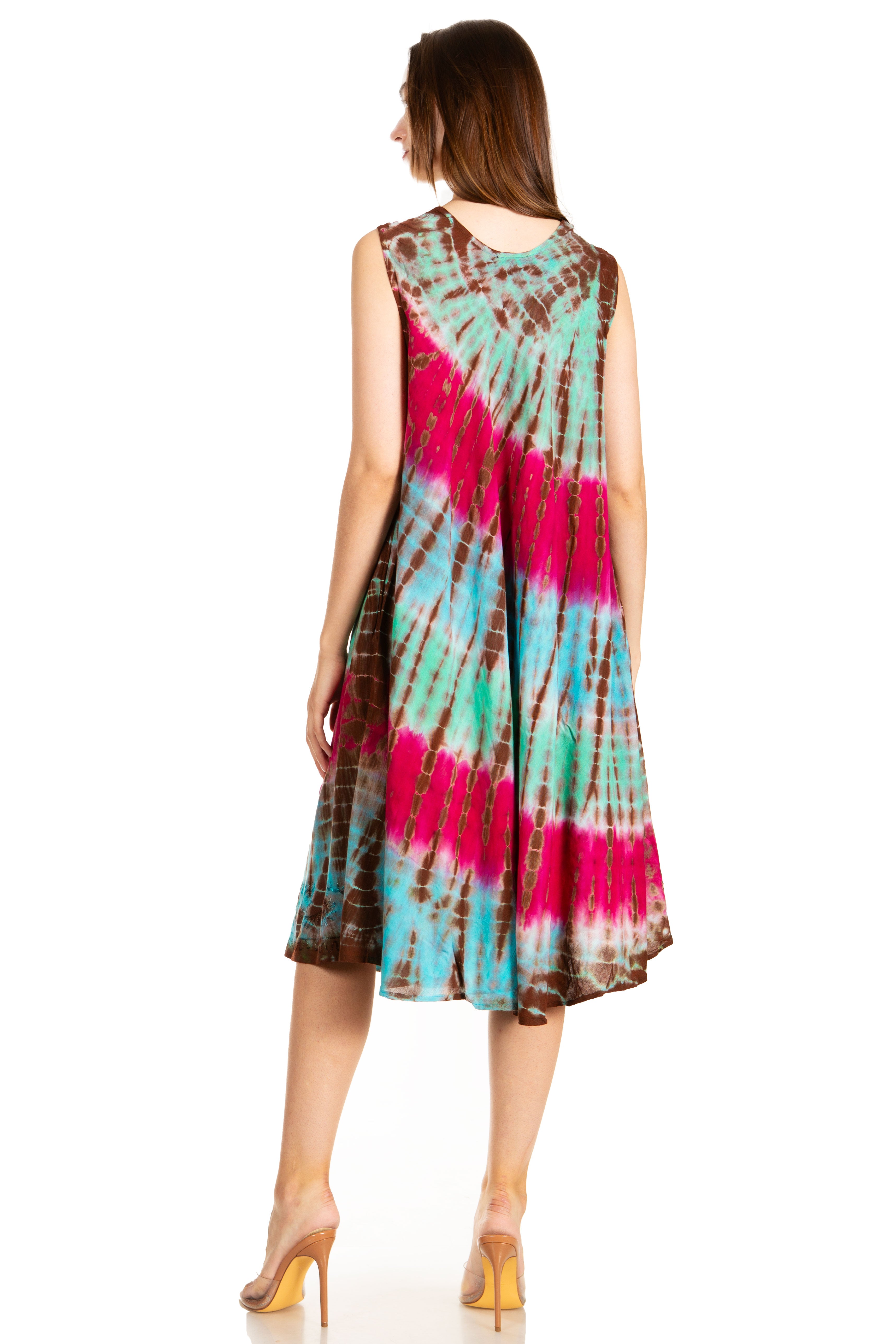 Woman wearing a tie-dye dress with pink, blue, and brown colors on a white background