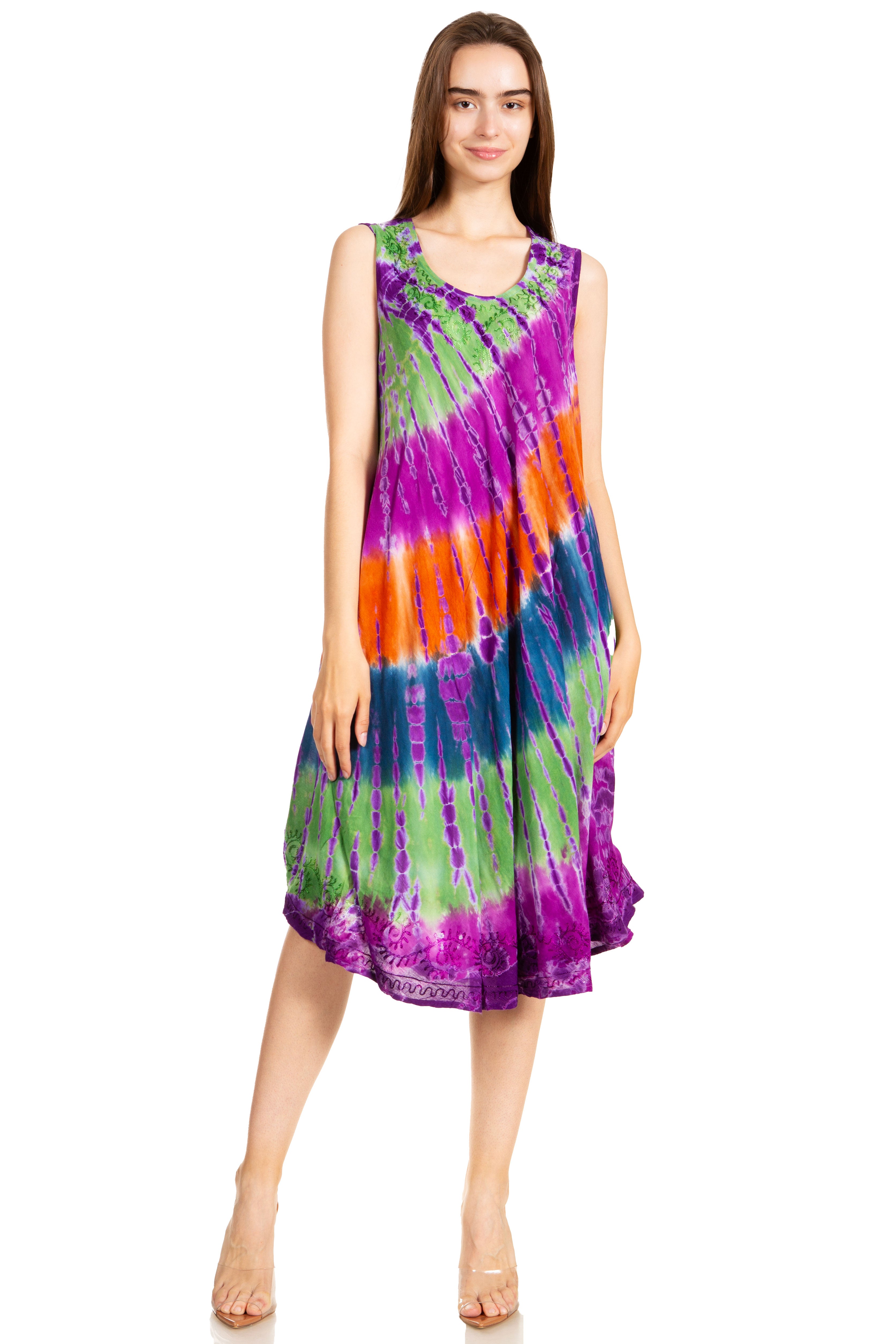 Woman wearing a tie-dye dress with purple, green, and orange colors on a white background