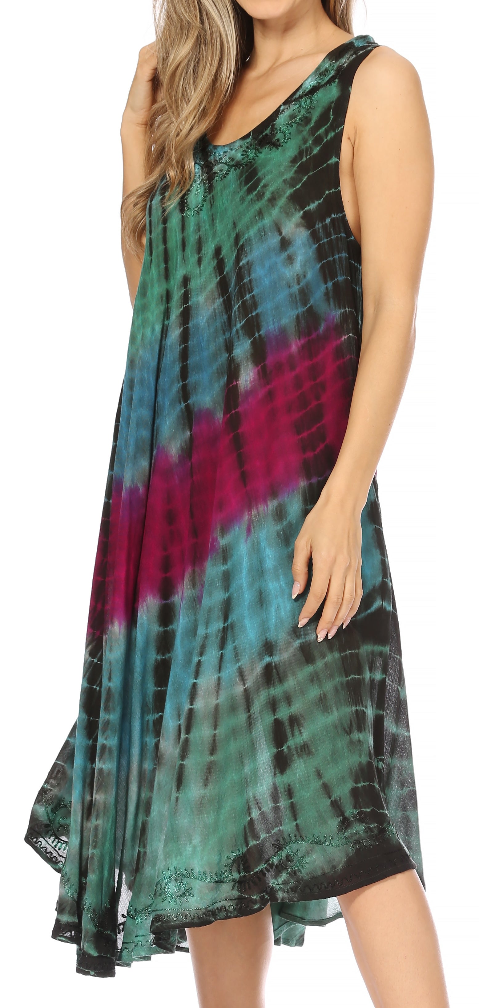 Woman wearing a tie-dye dress with green, pink, and black colors on a white background