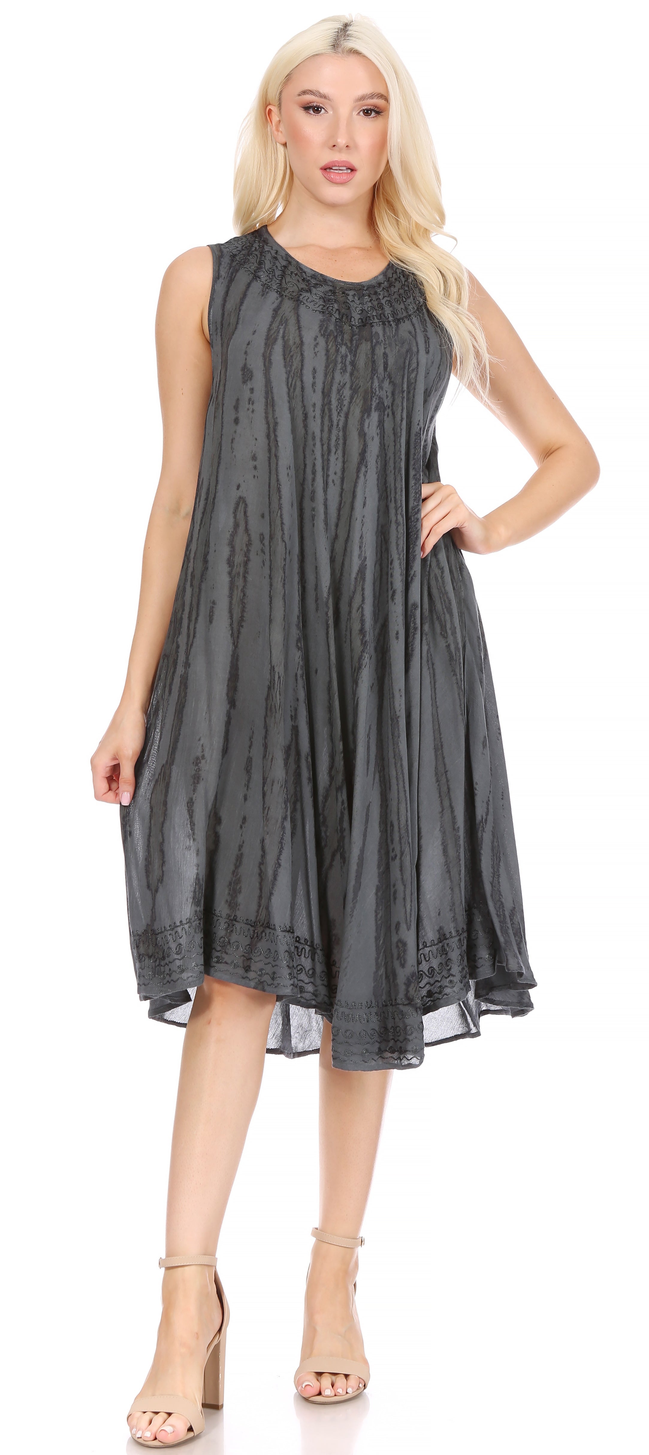 Woman wearing a sleeveless, dark gray dress on a white background