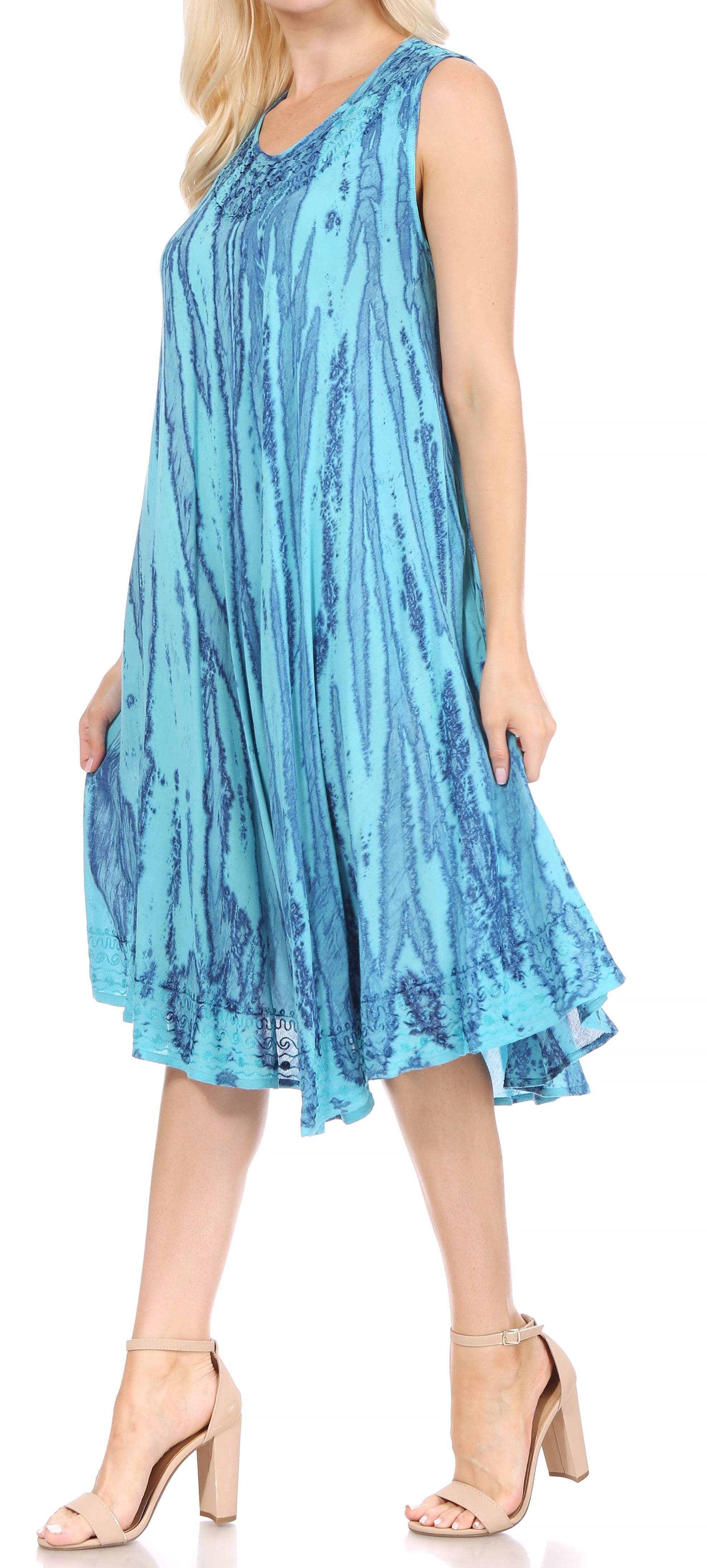 Woman wearing a blue sleeveless dress with a pattern.