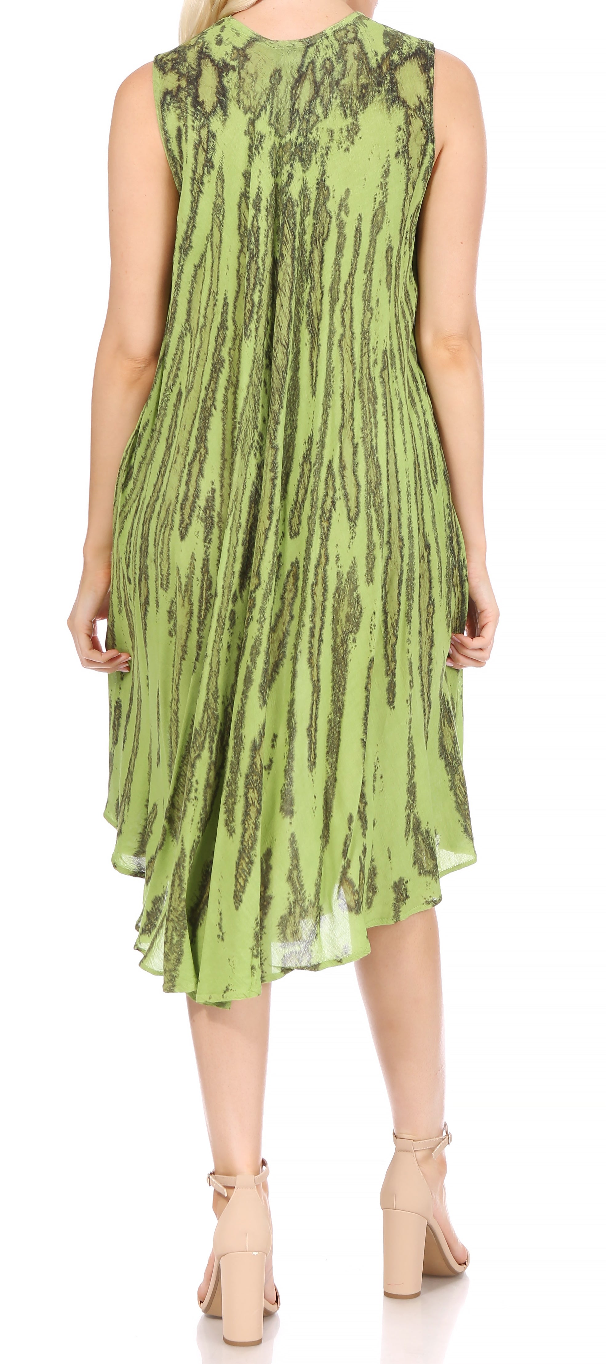 Green patterned dress worn by a person on a white background