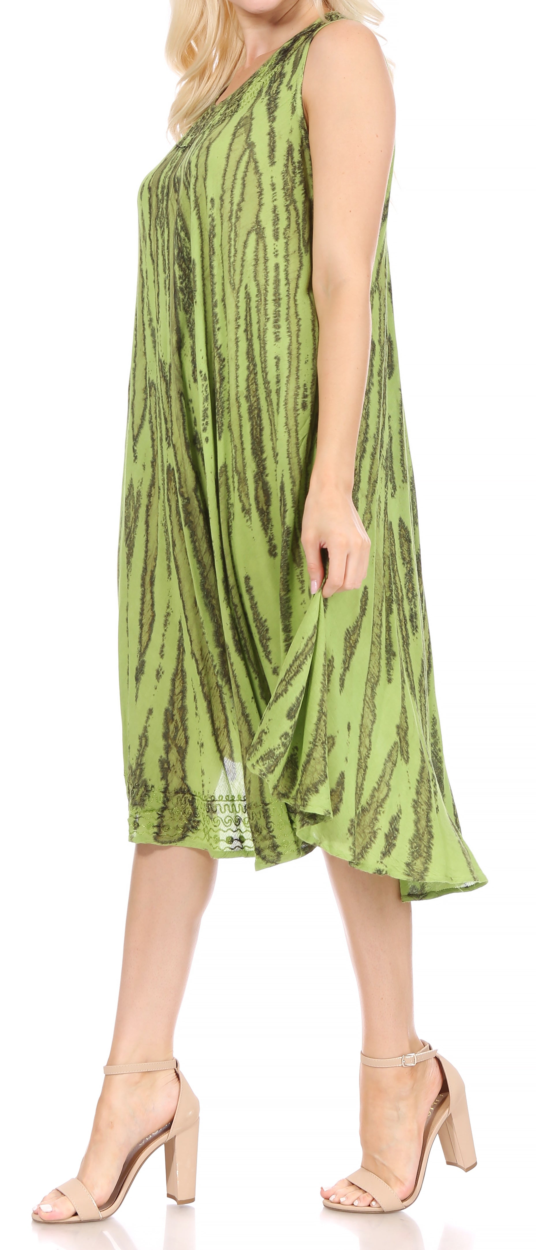 Woman wearing a green patterned dress on a white background