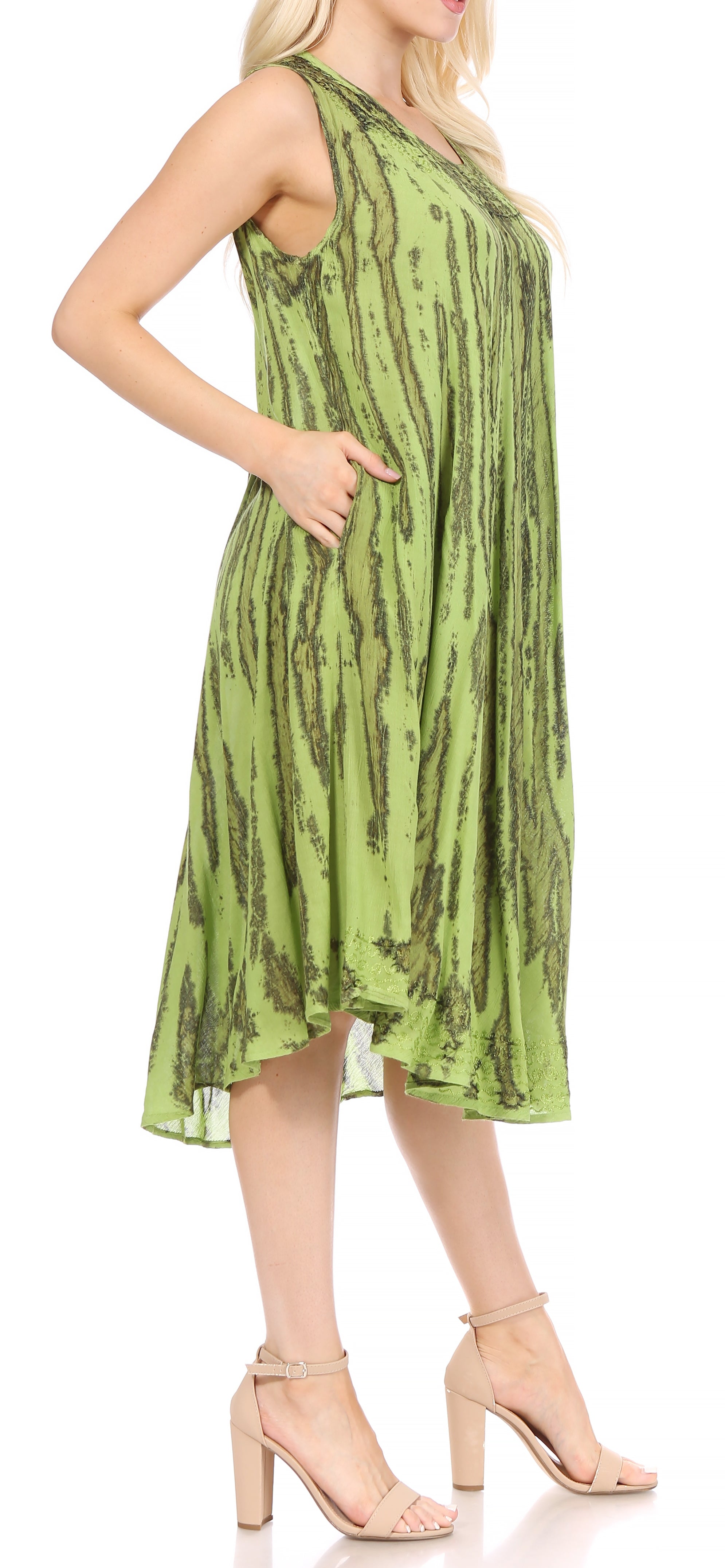 Woman wearing a green patterned dress on a white background