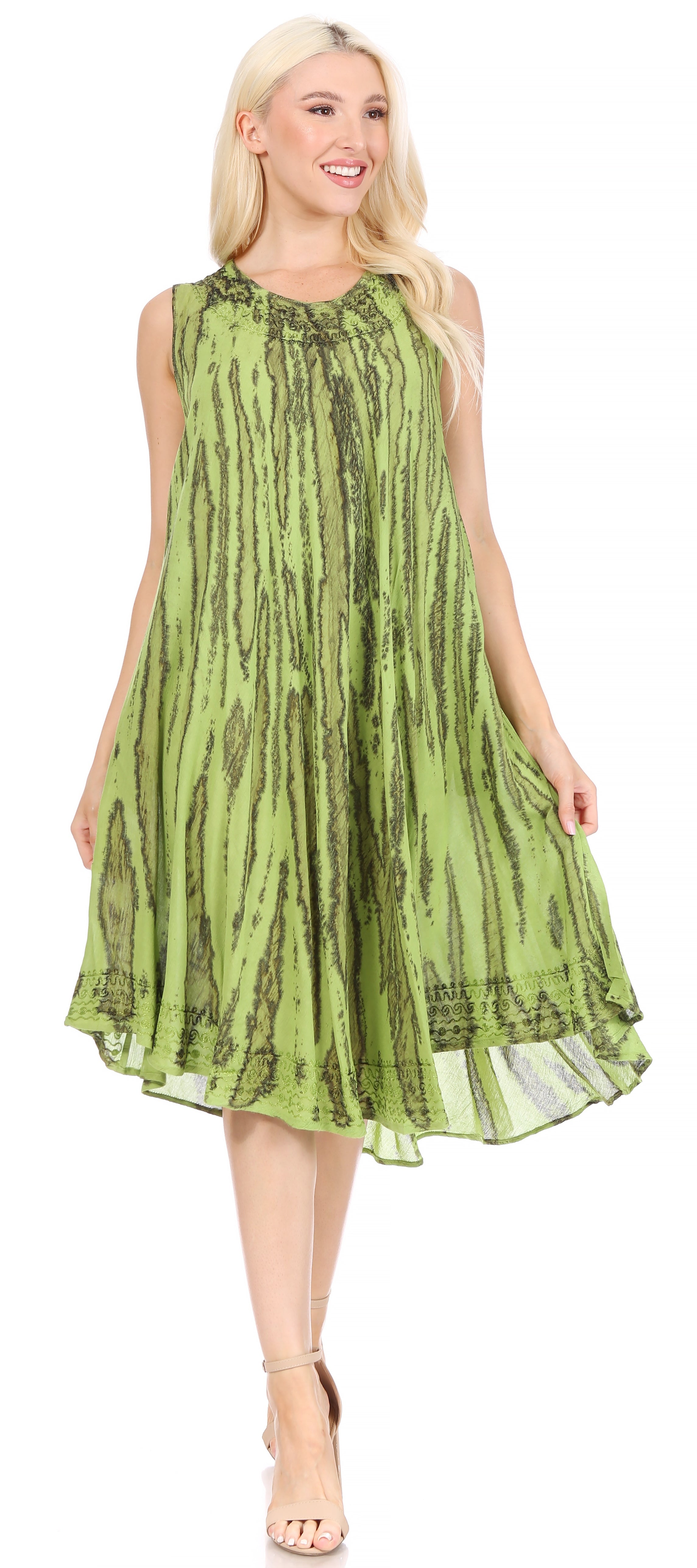 Woman wearing a green dress with a pattern on a white background