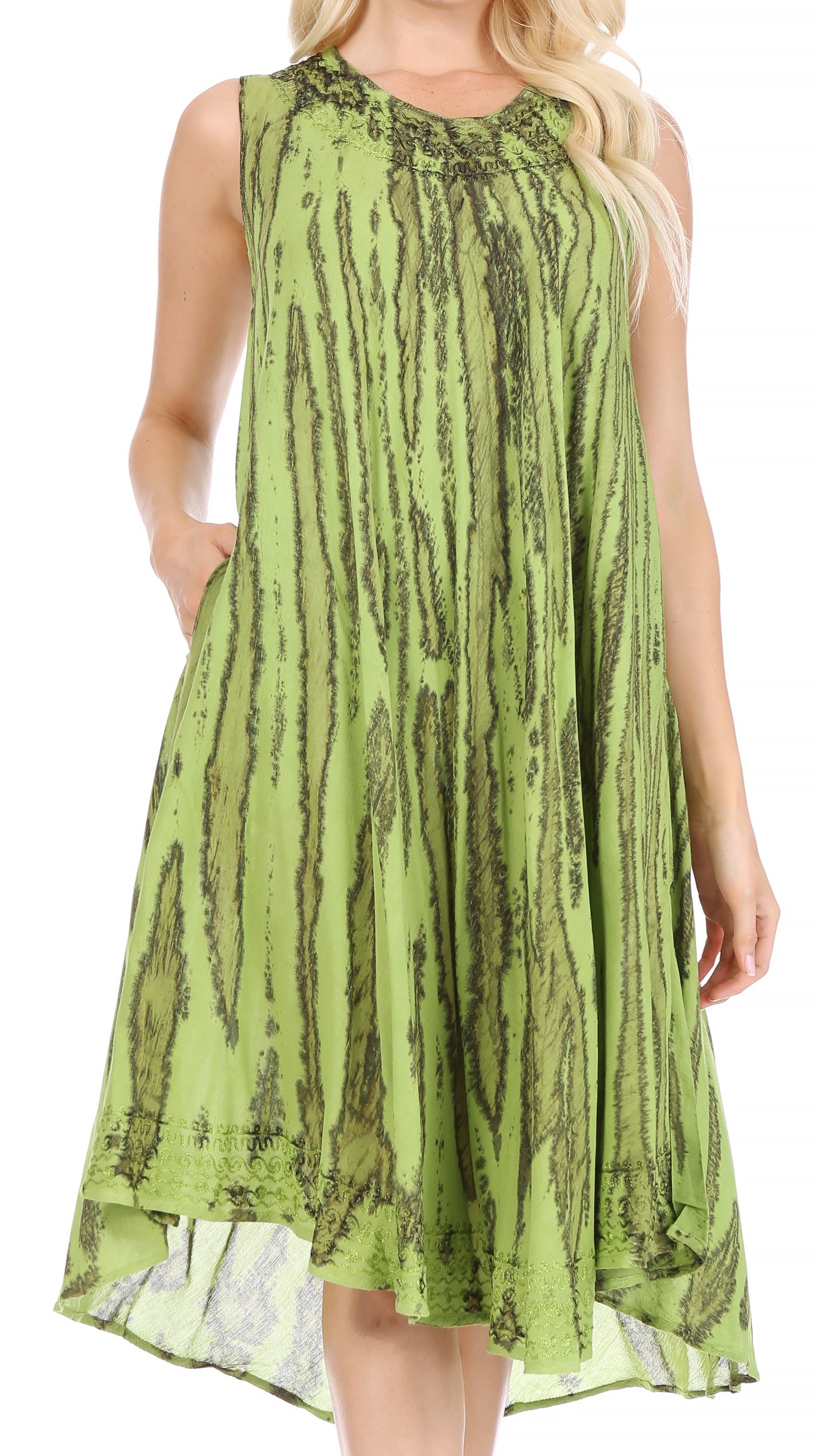 Woman wearing a green patterned dress on a white background