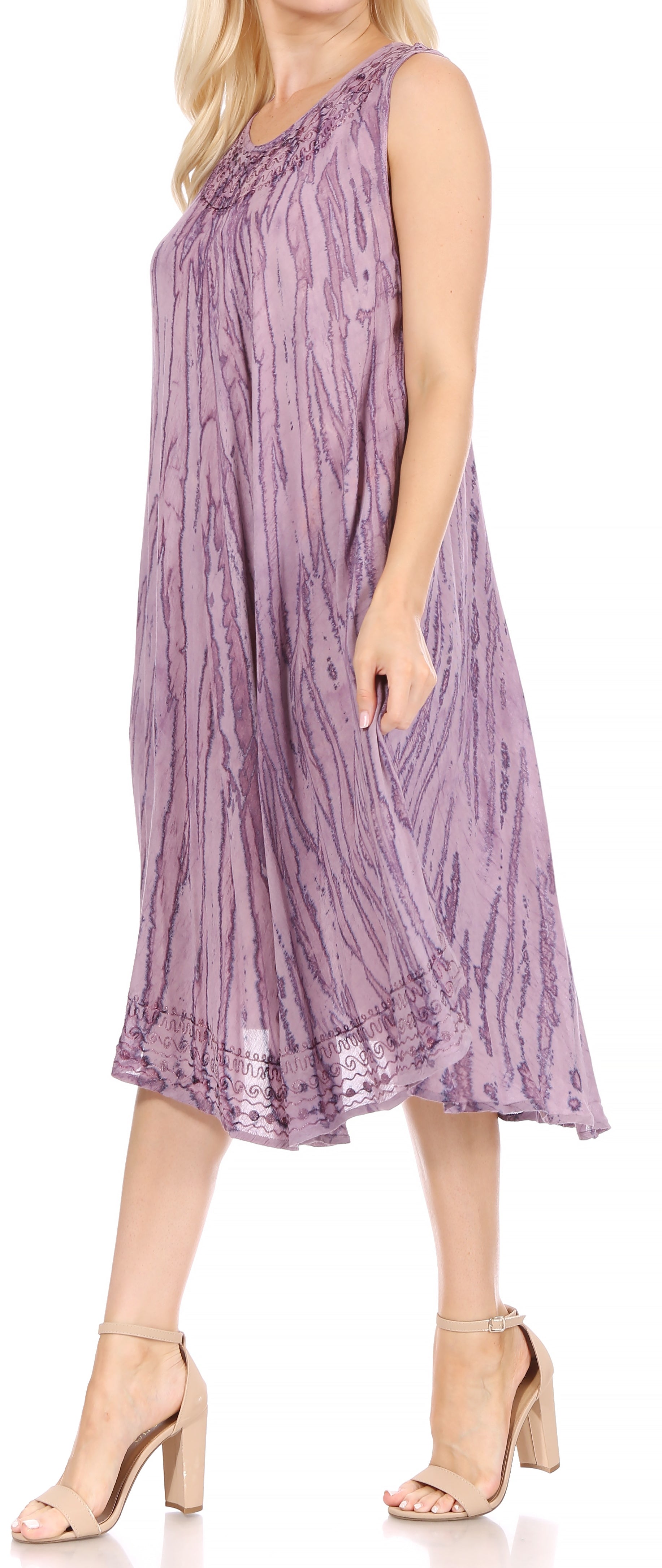 Woman wearing a purple patterned dress on a white background