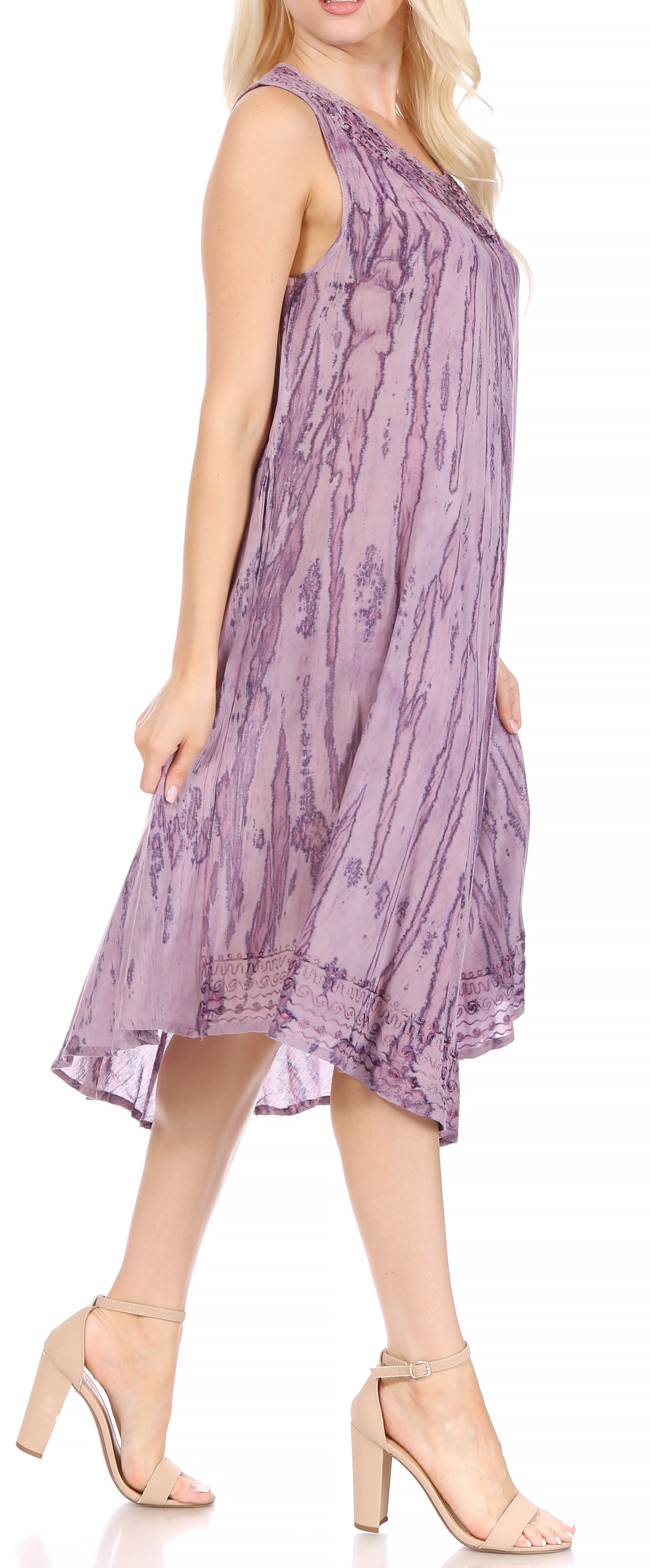 Woman wearing a purple floral dress on a white background