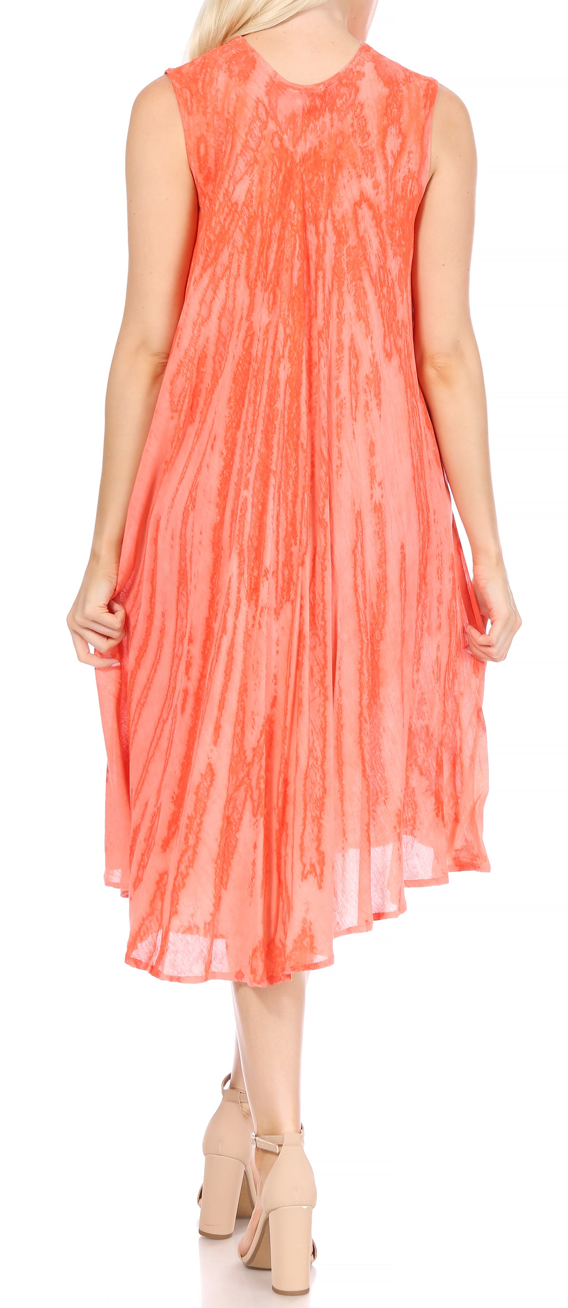 Woman wearing a coral sleeveless dress on a white background
