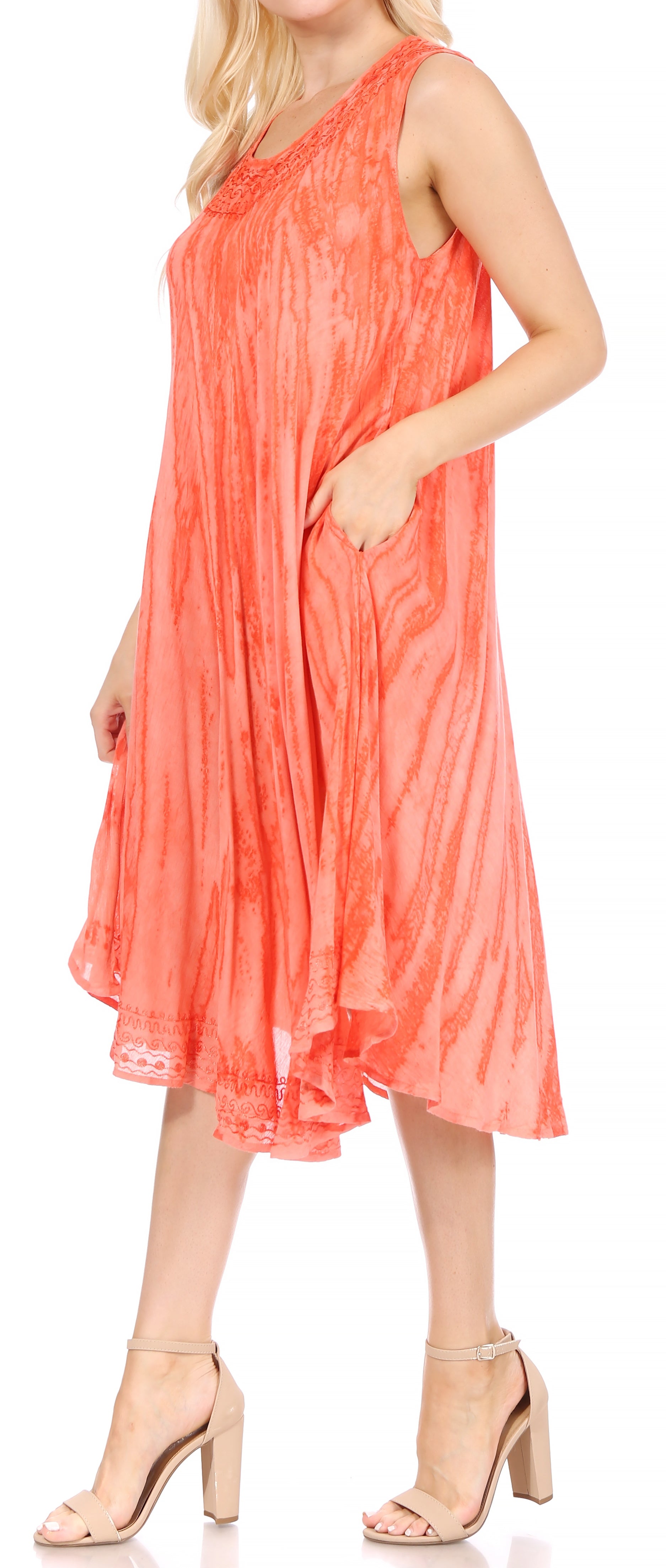 Woman wearing a coral dress on a white background