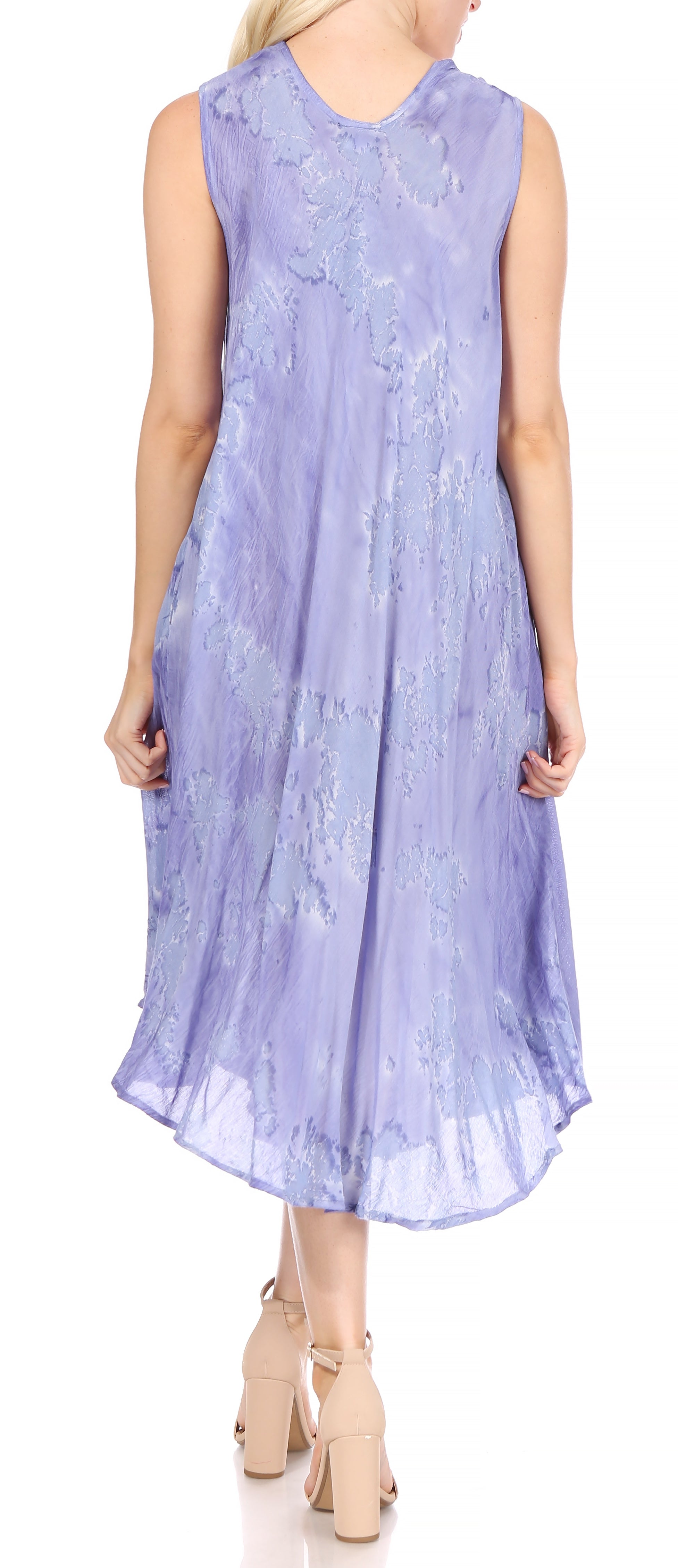 Woman wearing a light purple sleeveless dress with floral patterns on a white background