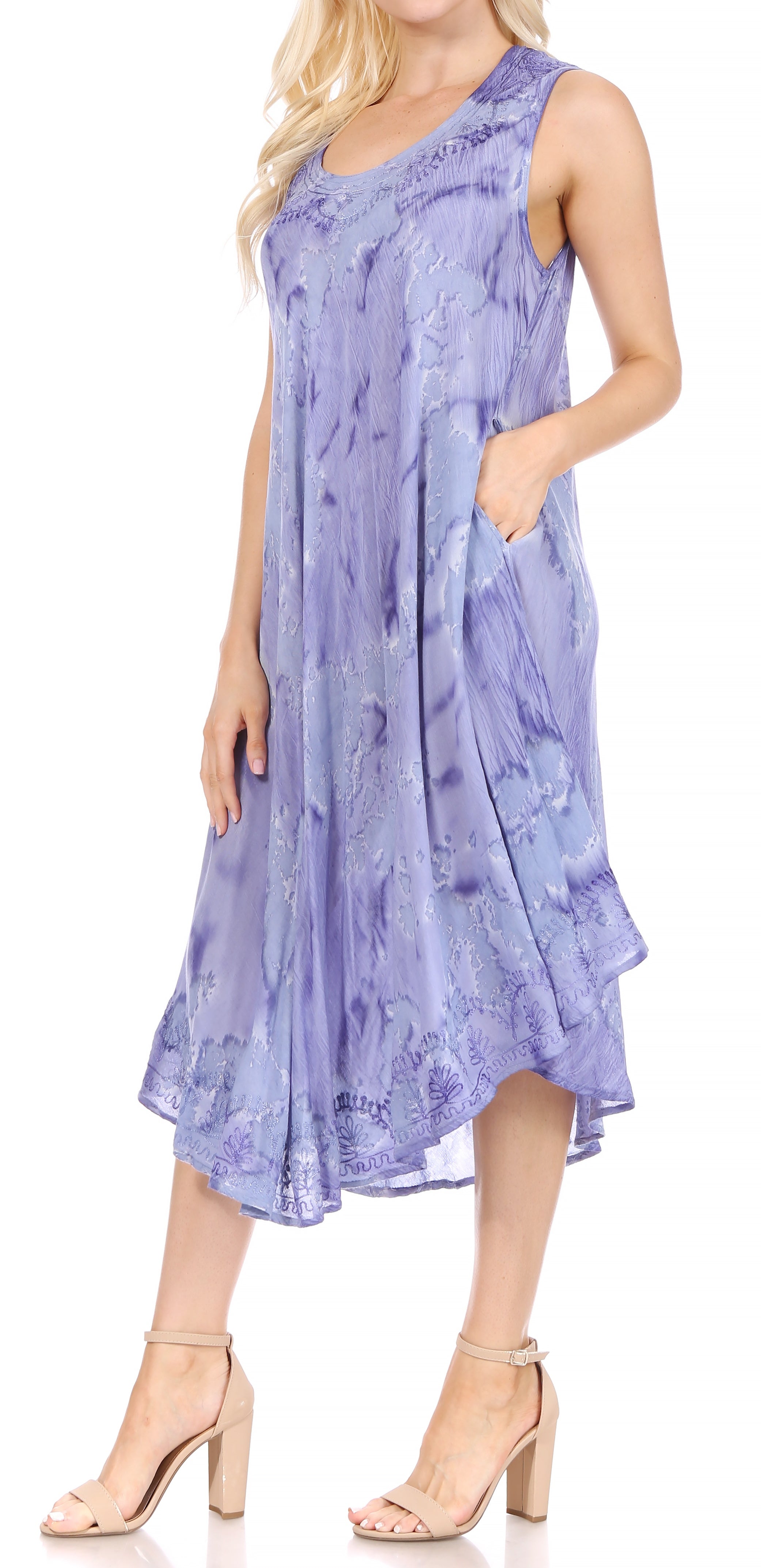 Woman wearing a sleeveless purple dress with a floral pattern on a white background