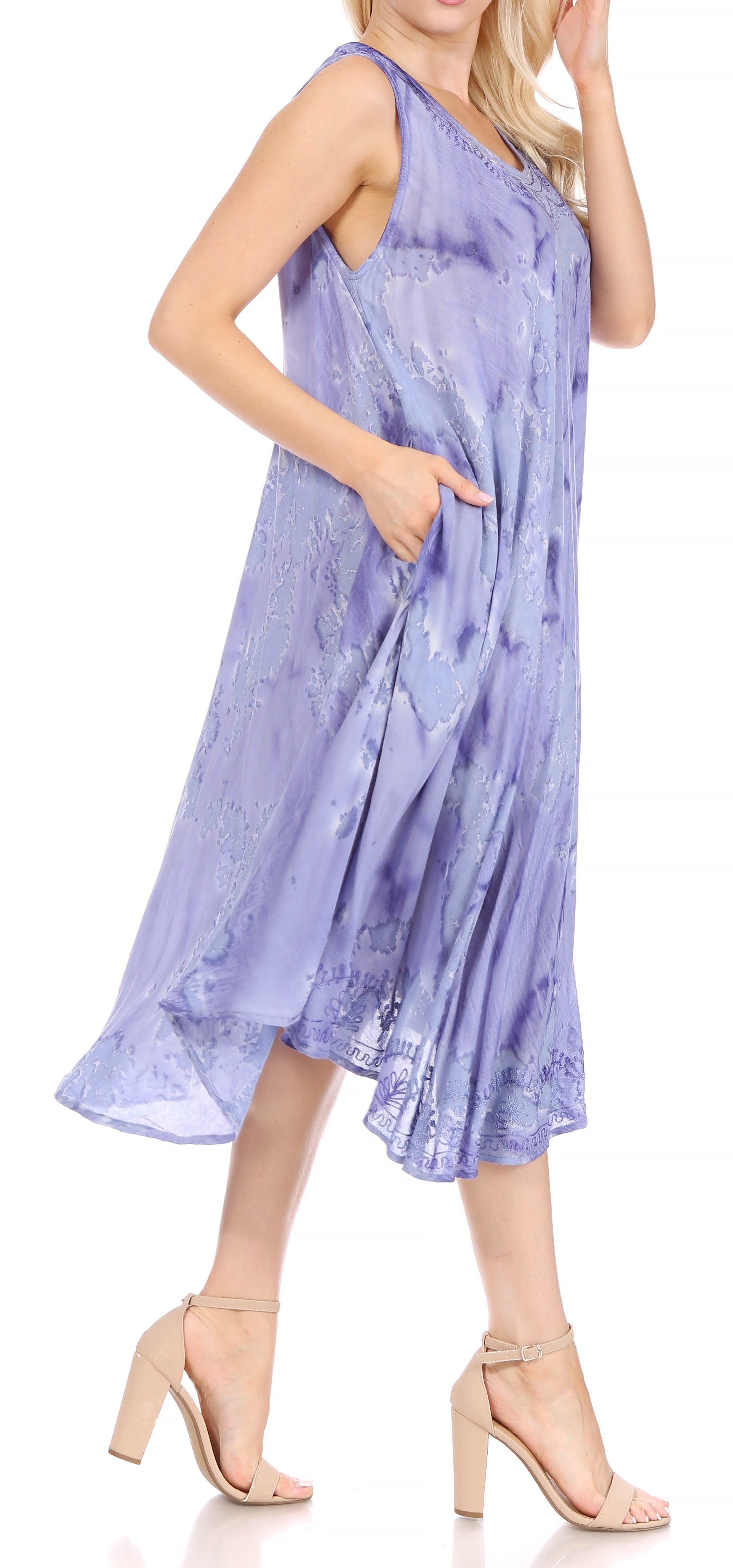 Woman wearing a light purple tie-dye dress on a white background