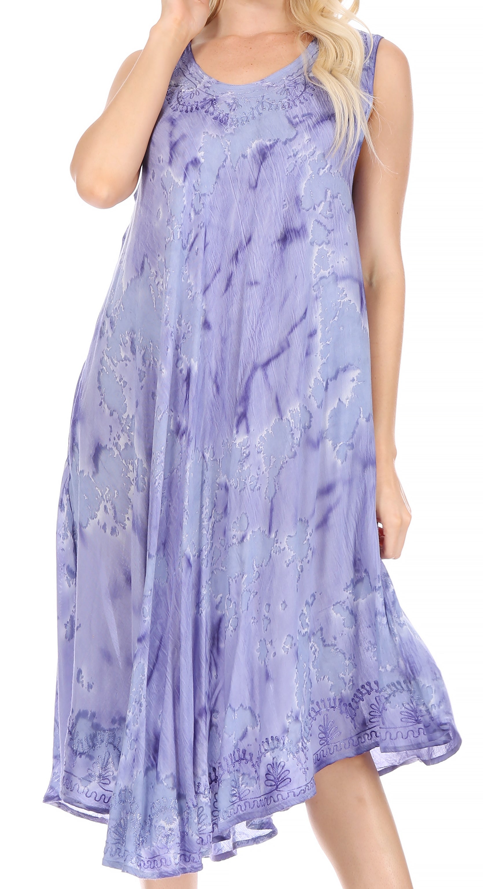 Woman wearing a sleeveless purple dress with floral pattern on a white background
