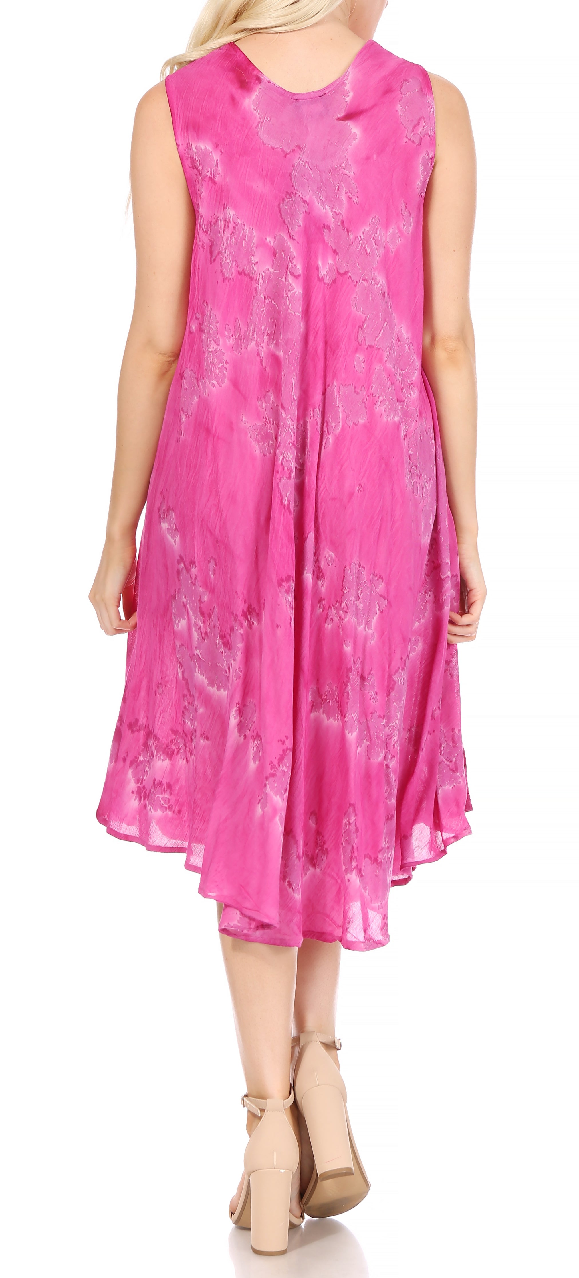 Woman wearing a pink dress with a floral pattern on a white background