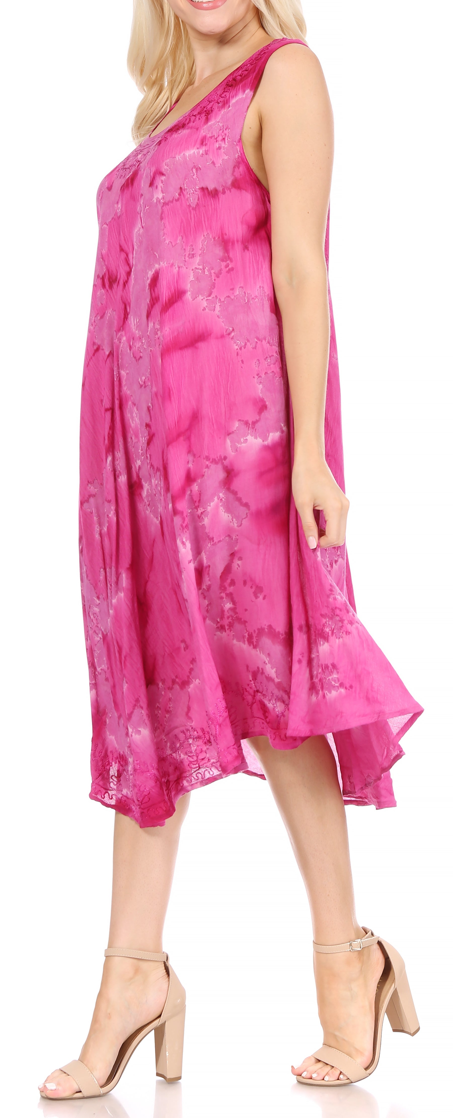 Woman wearing a pink dress with floral pattern on a white background