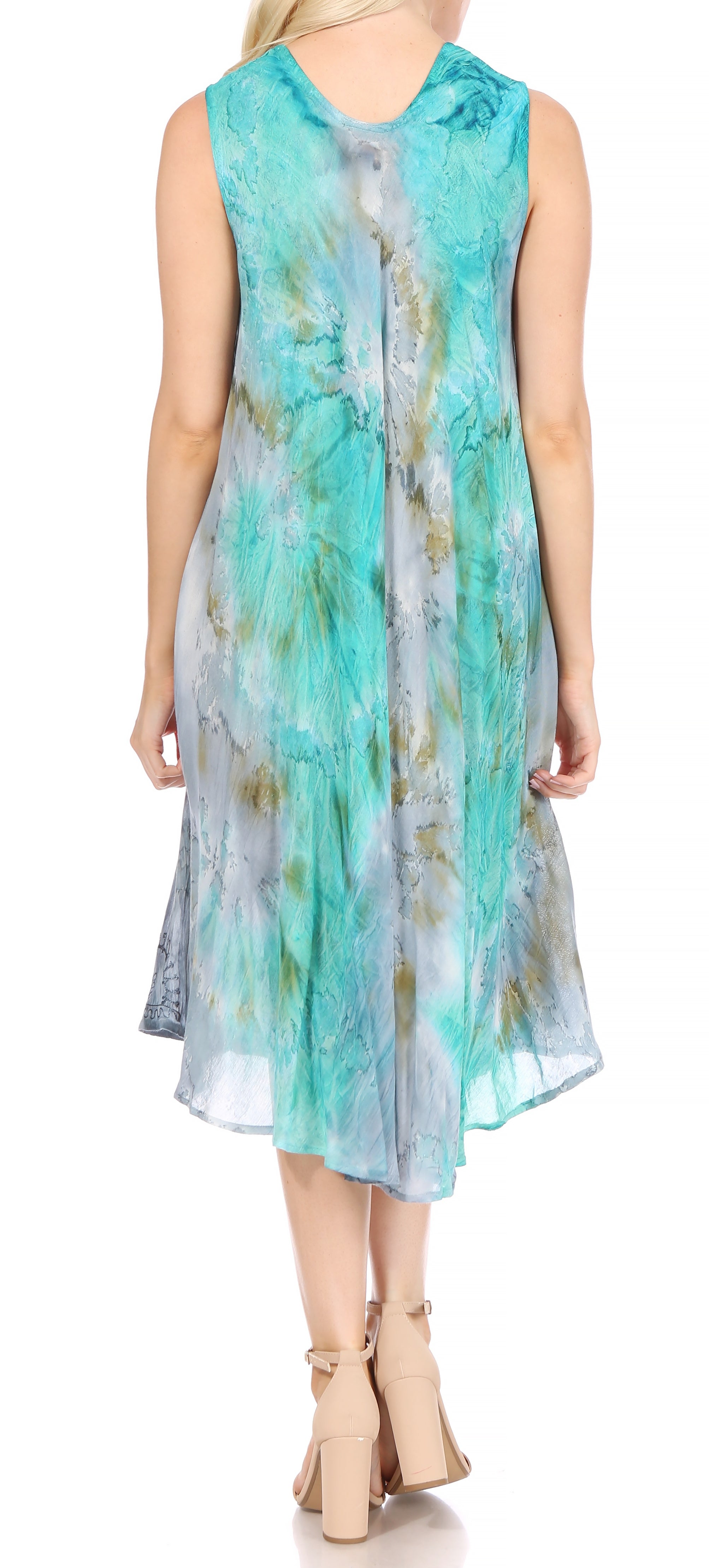Woman wearing a sleeveless, light blue and green patterned dress on a white background