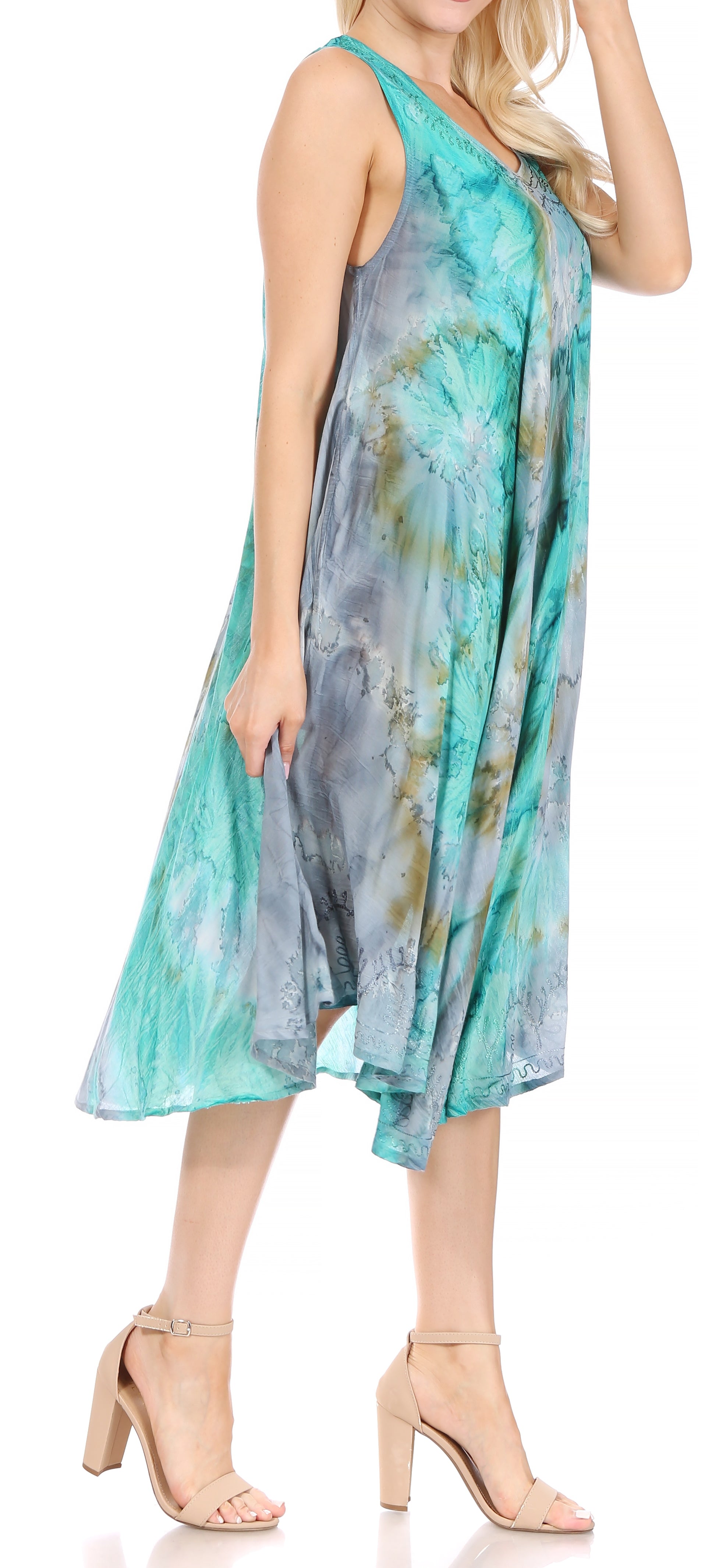 Woman wearing a sleeveless, tie-dye dress with a white background