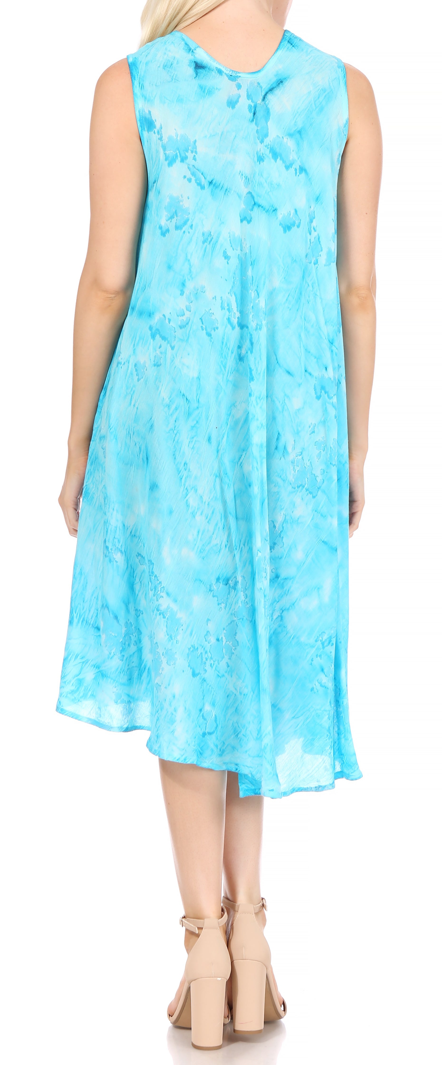 Woman wearing a light blue sleeveless dress with a floral pattern on a white background