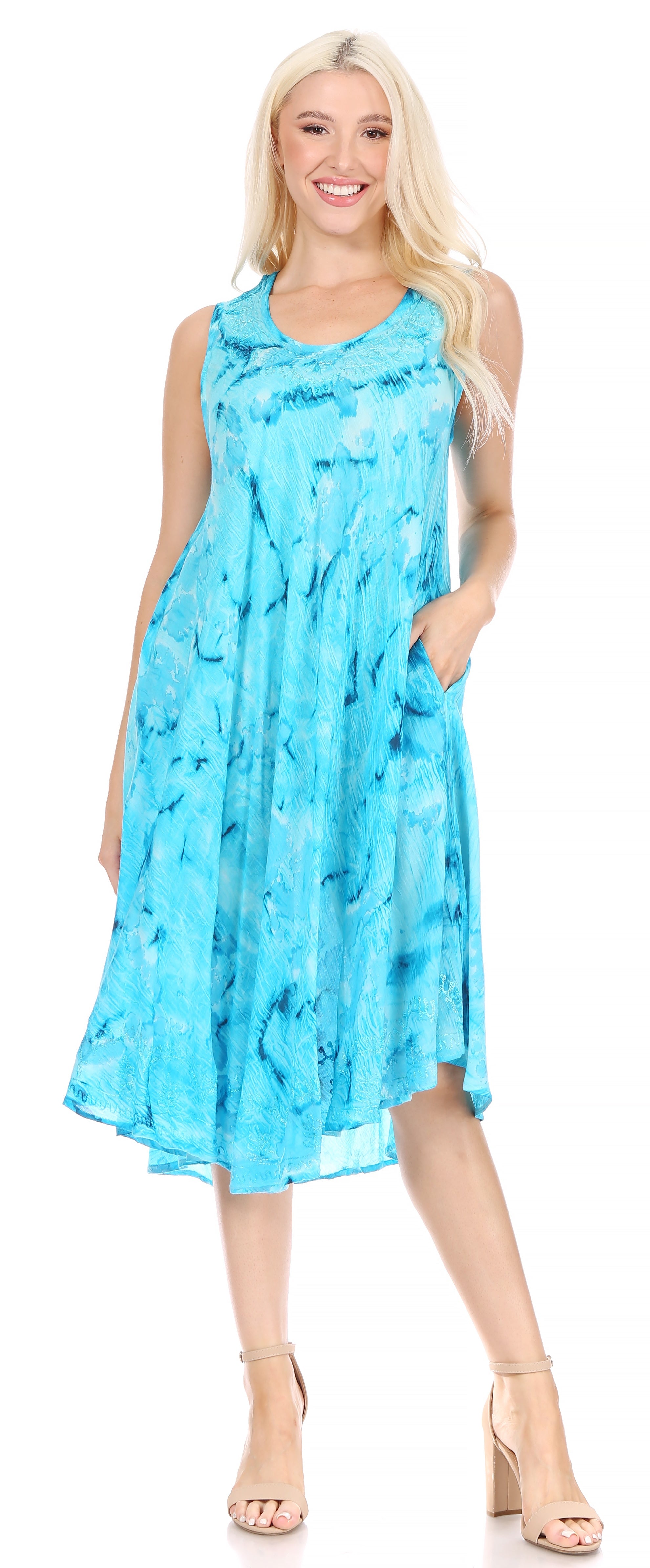 Woman wearing a blue tie-dye dress on a white background