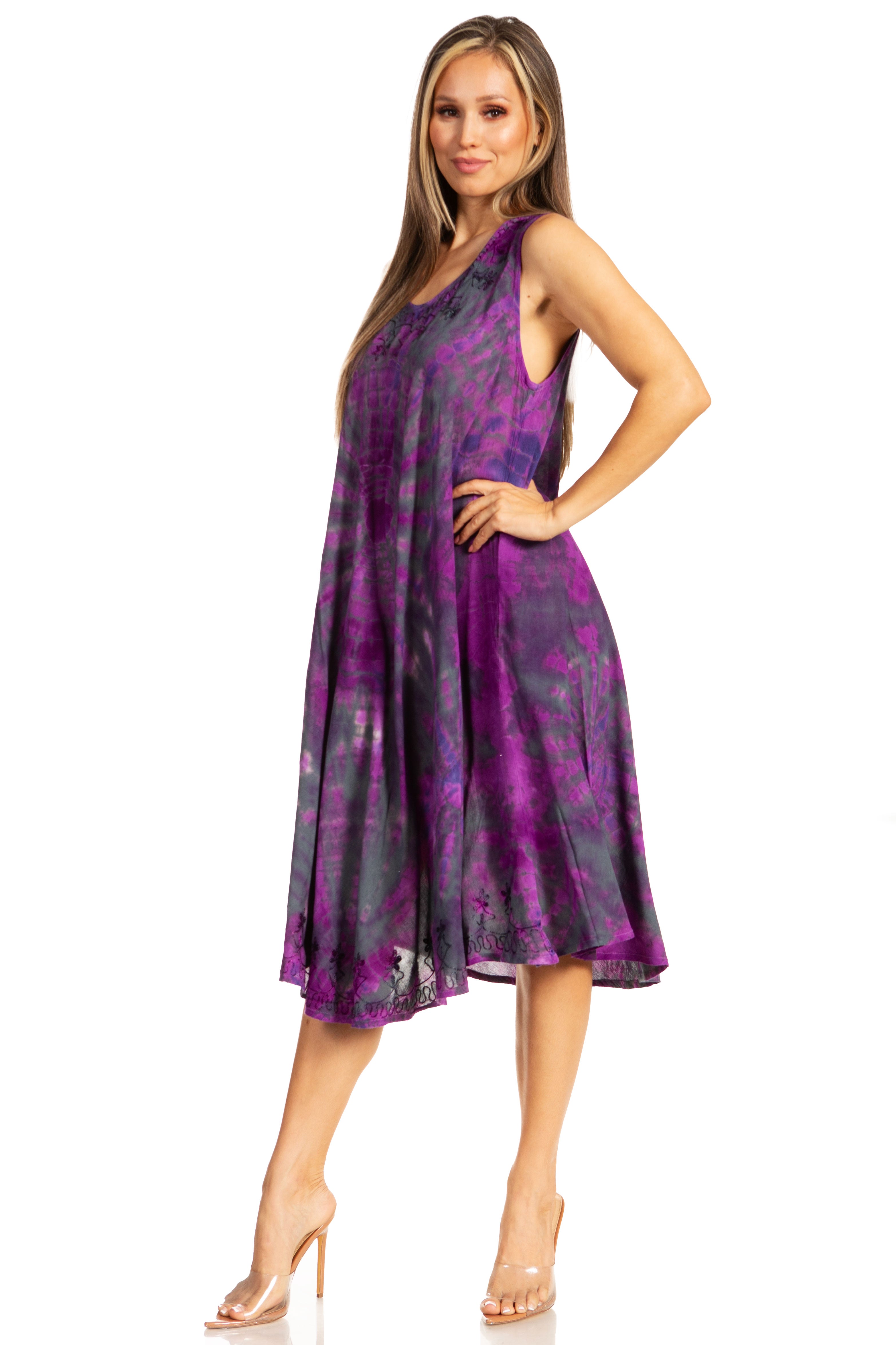 Woman wearing a purple tie-dye dress on a white background