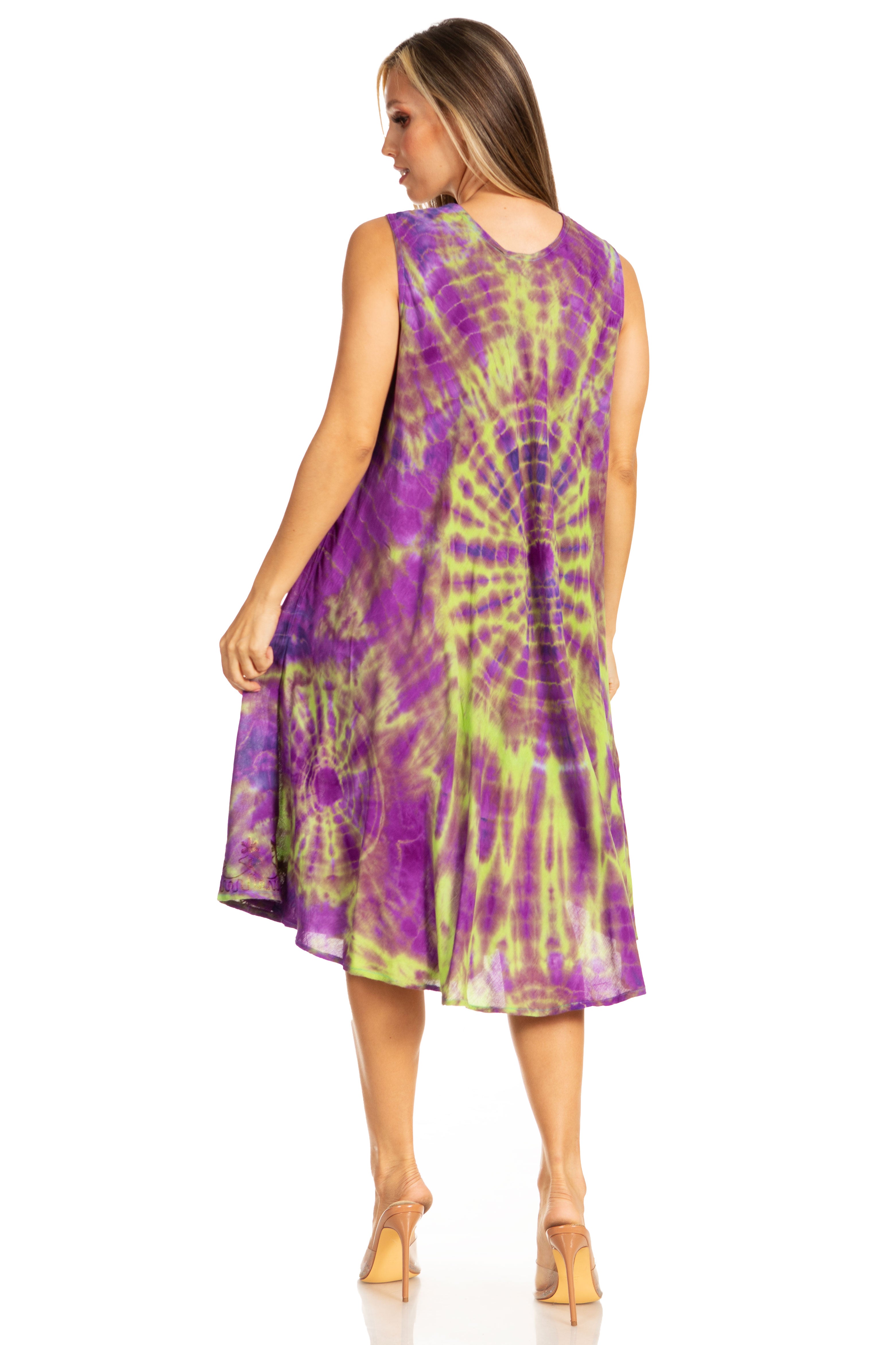 Woman wearing a tie-dye dress with purple and green pattern on a white background