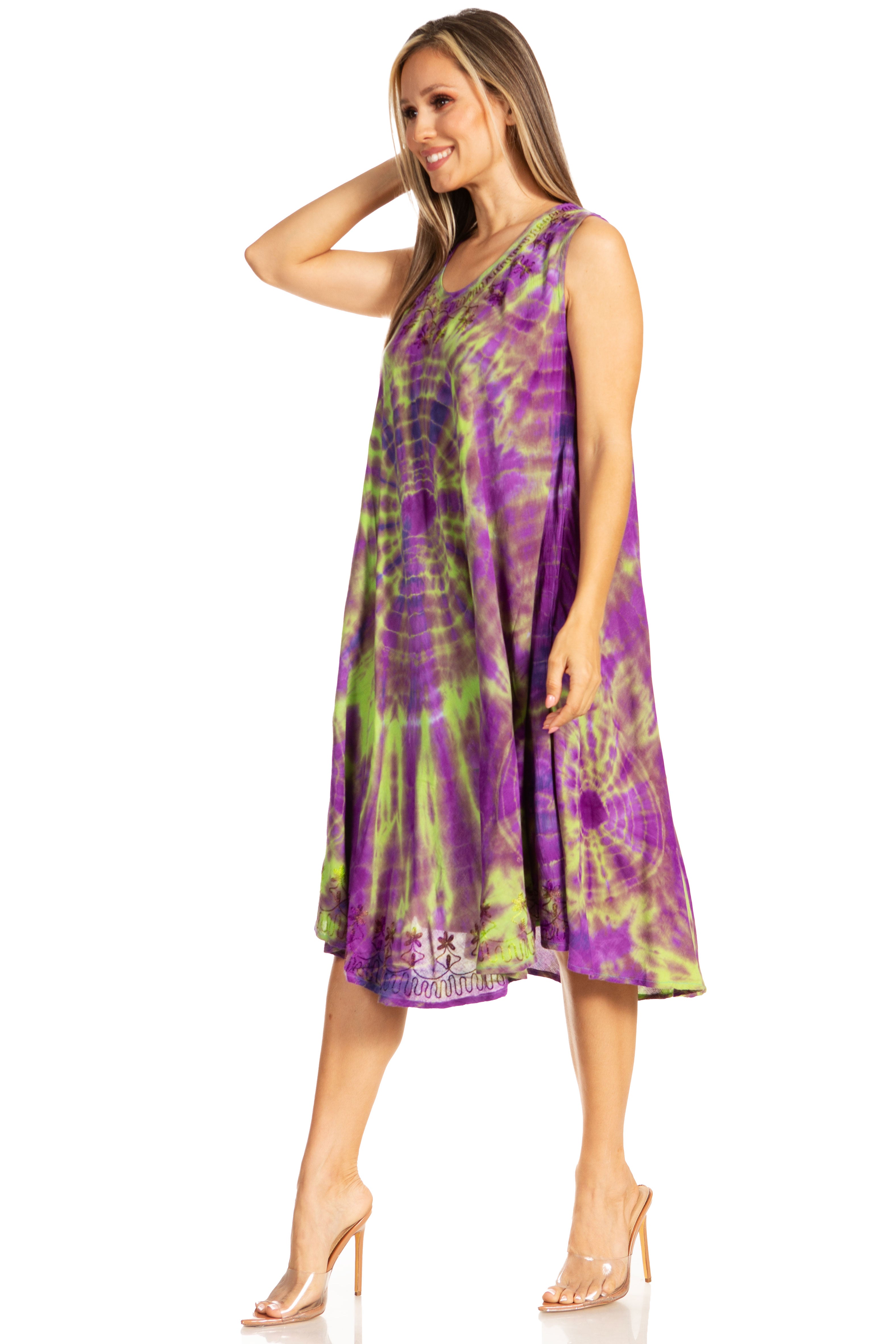 Woman wearing a tie-dye dress with purple and green pattern on a white background