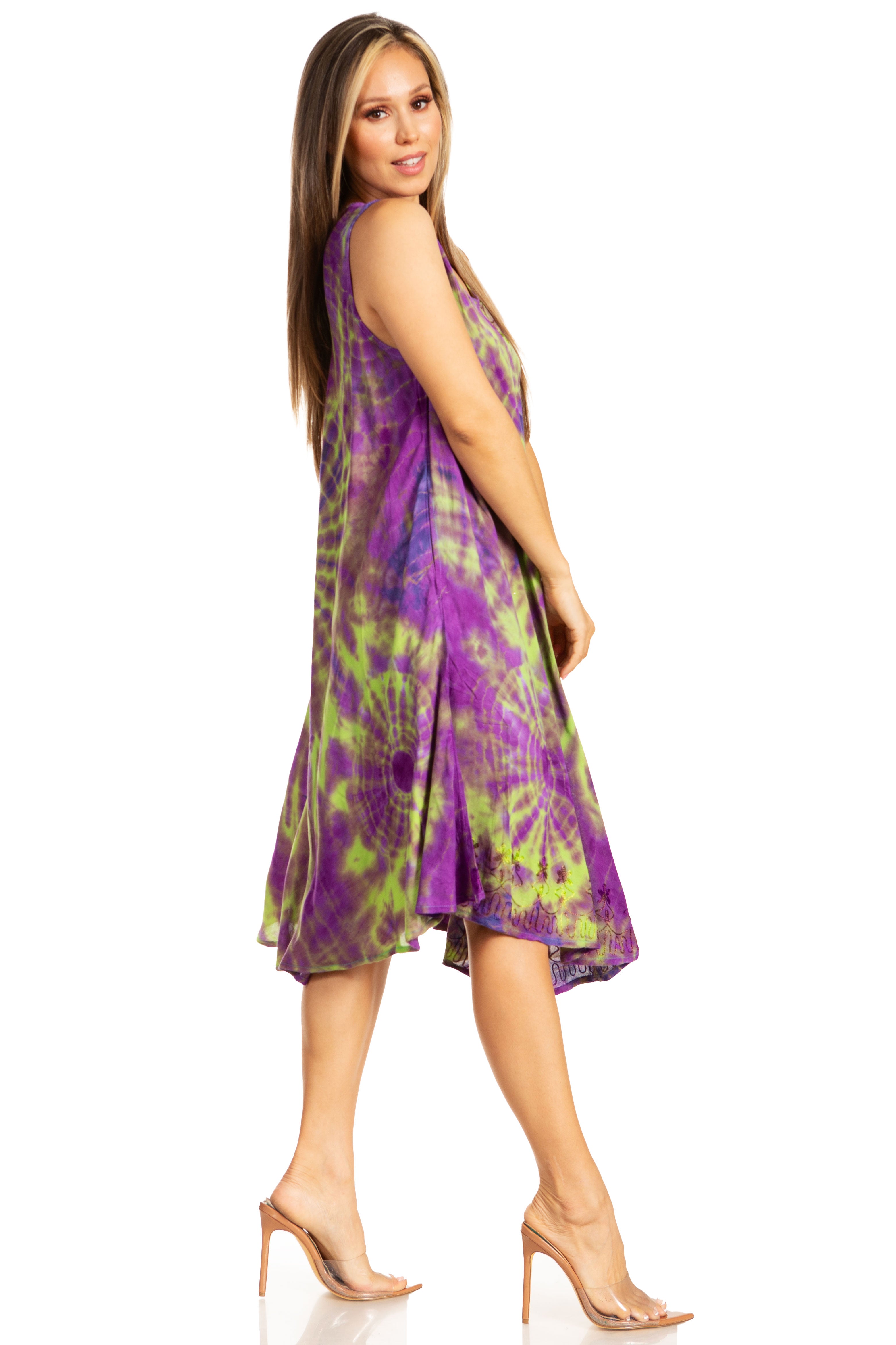Woman wearing a tie-dye dress with purple and green patterns on a white background