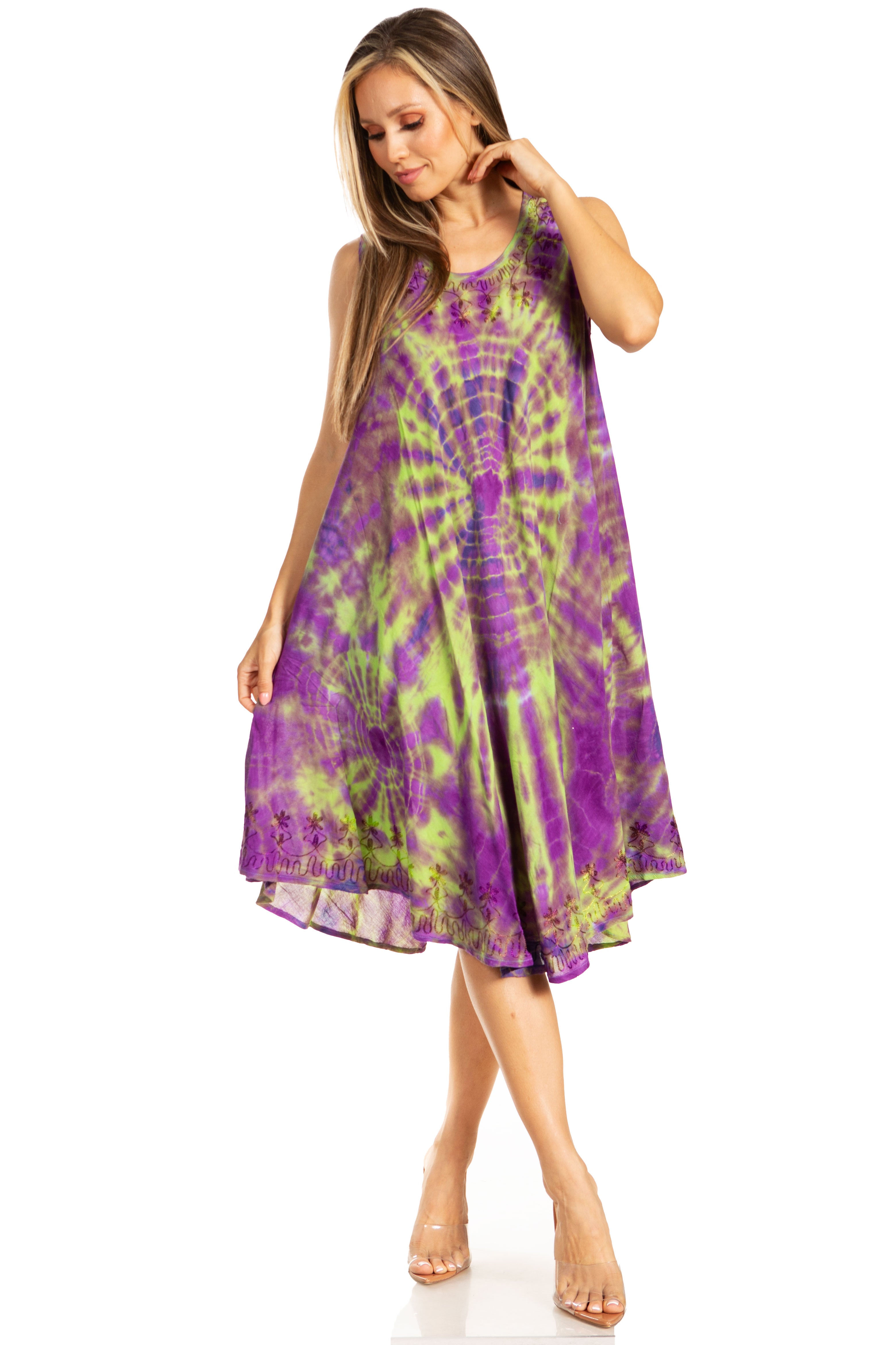Woman wearing a tie-dye dress with purple and green pattern on a white background