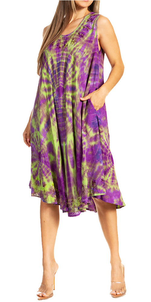 Woman wearing a tie-dye dress with purple and green patterns on a white background