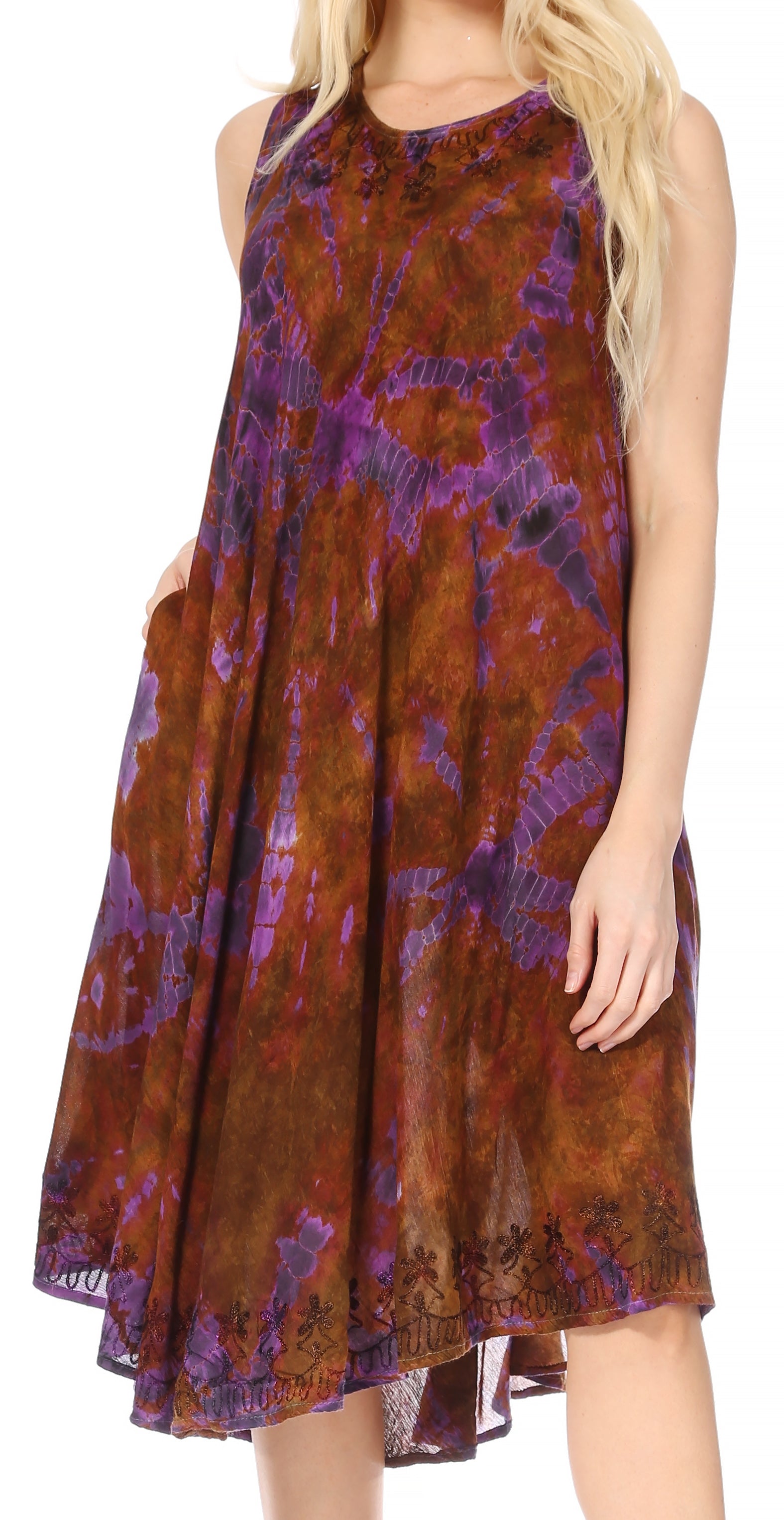 Woman wearing a sleeveless dress with a tie-dye pattern in shades of purple and brown.