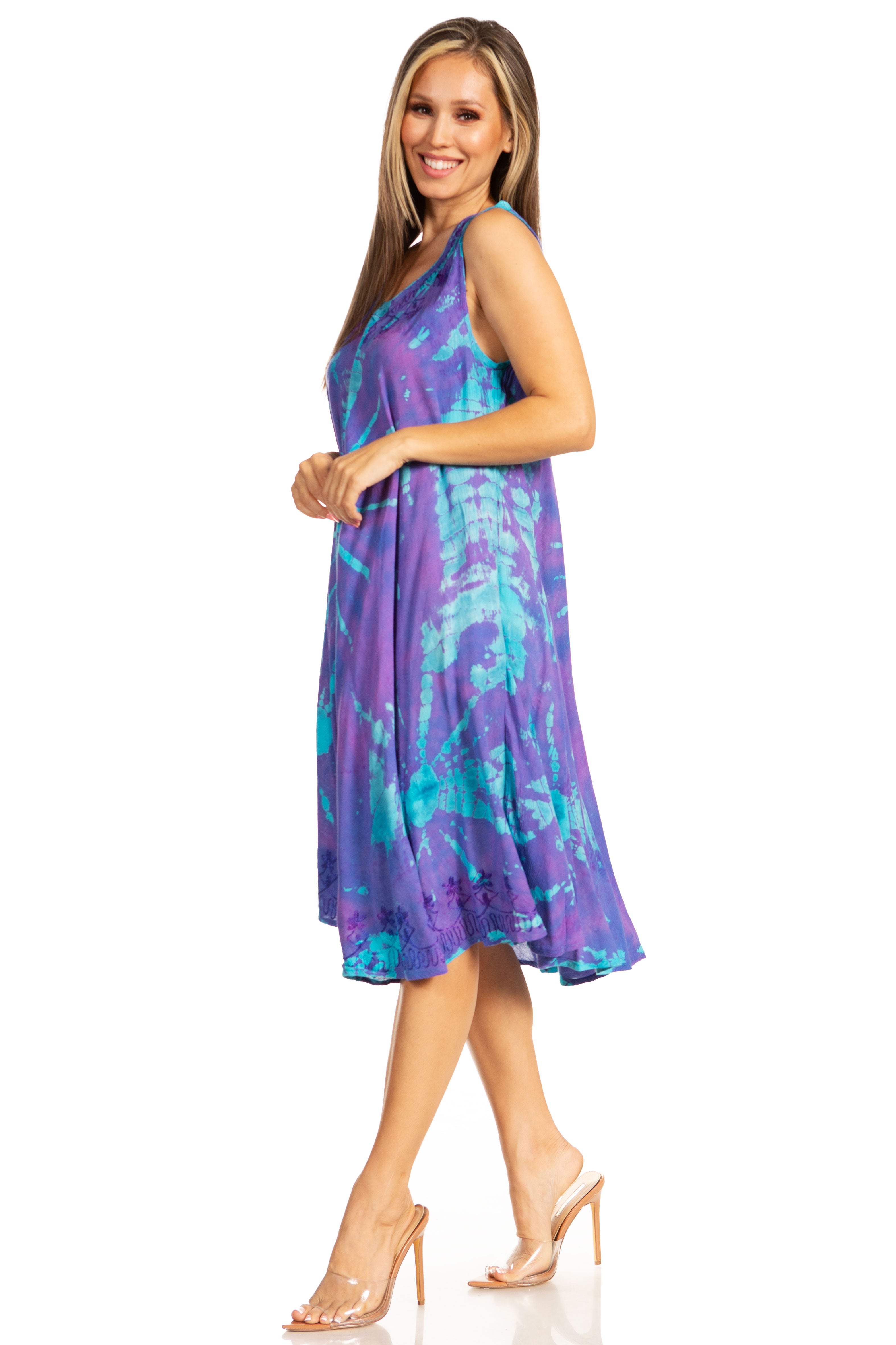 Woman wearing a purple and blue patterned dress on a white background