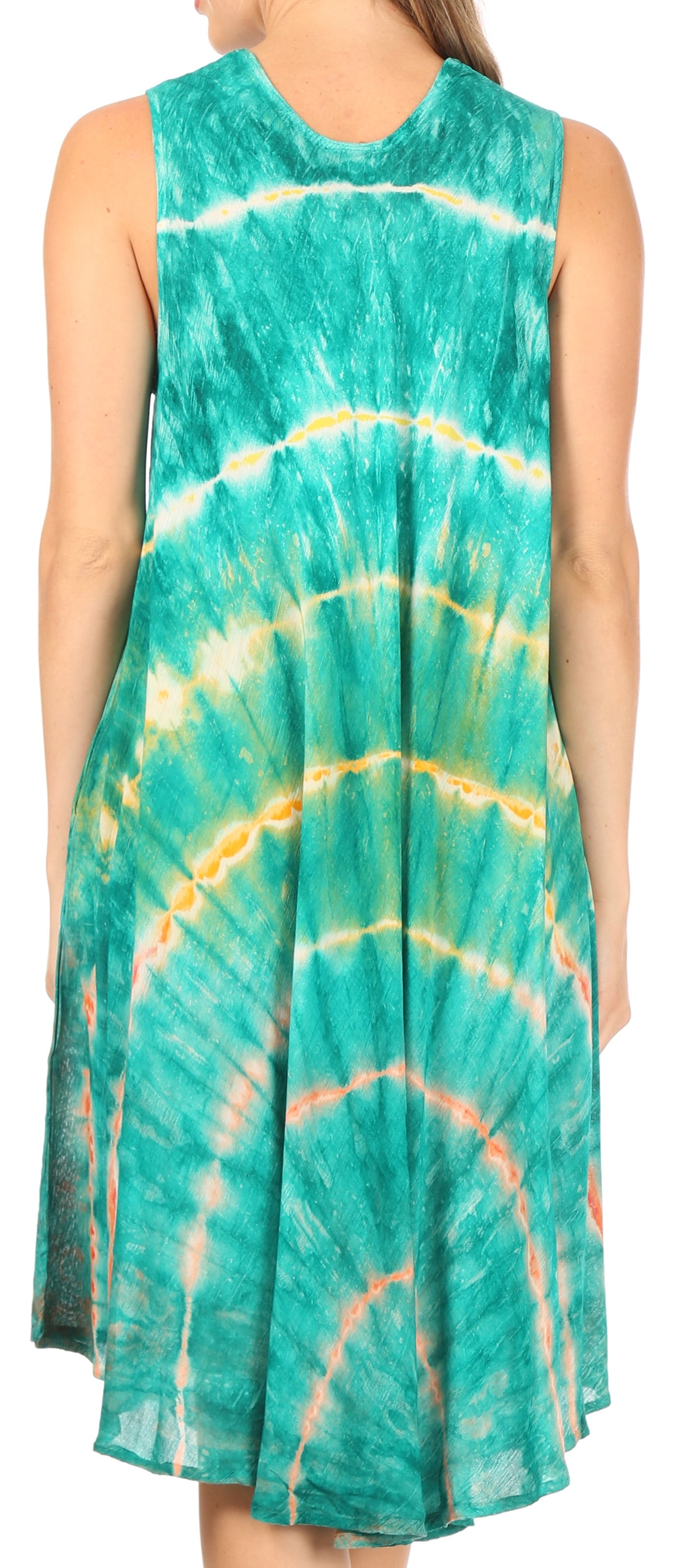 Woman wearing a tie-dye dress with green, yellow, and orange patterns.