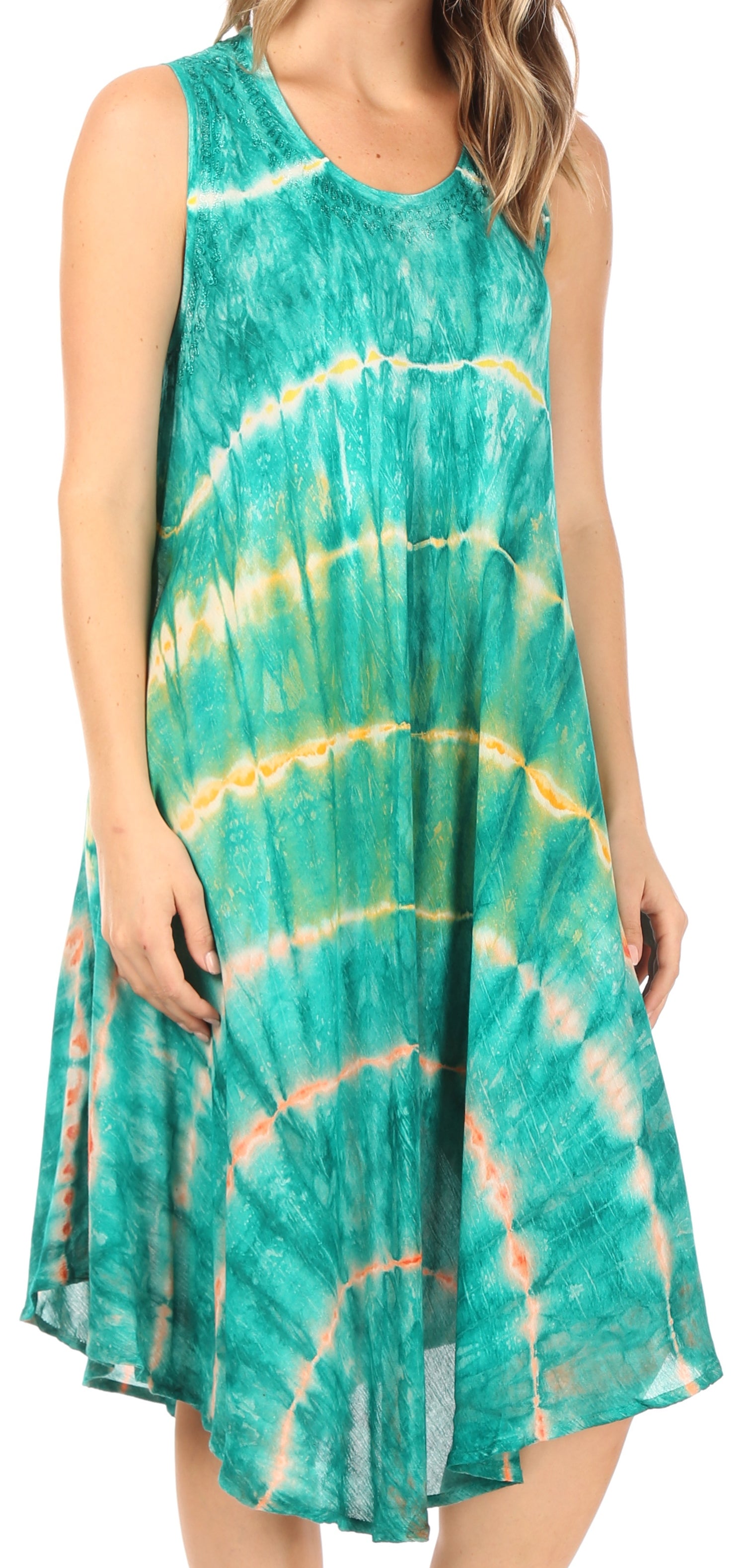 Woman wearing a tie-dye dress with green and yellow patterns on a white background