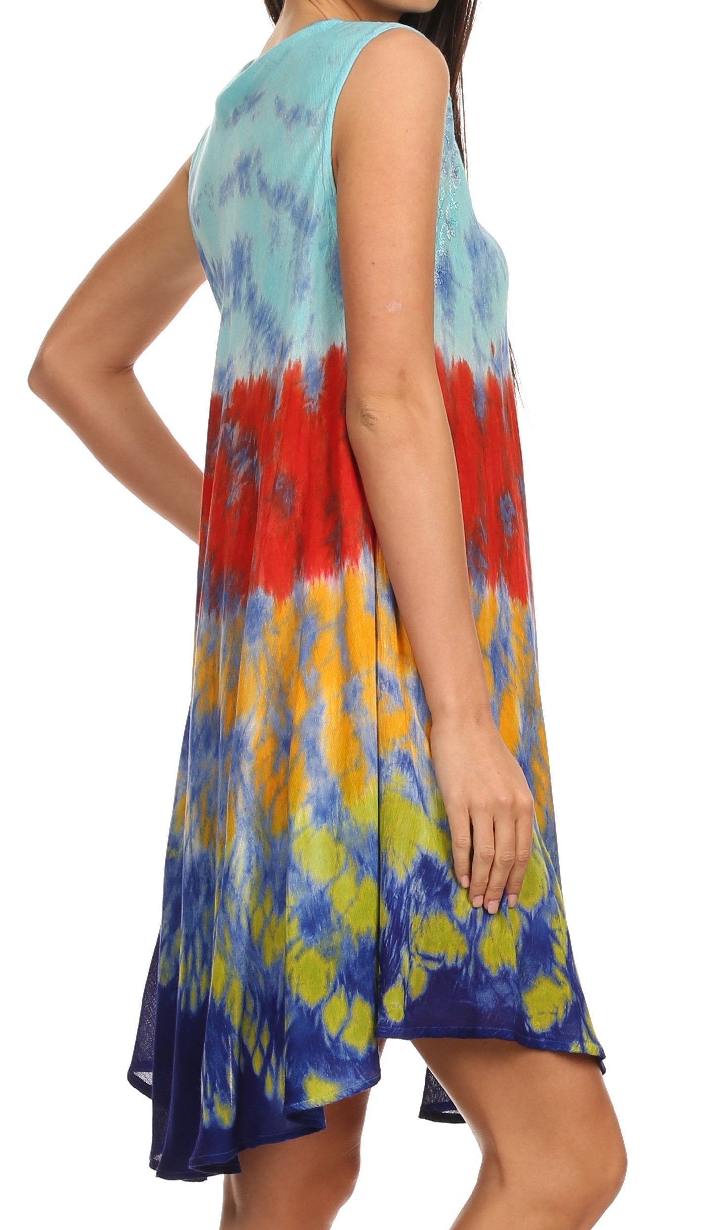 Woman wearing a tie-dye dress with red, yellow, and blue patterns on a white background