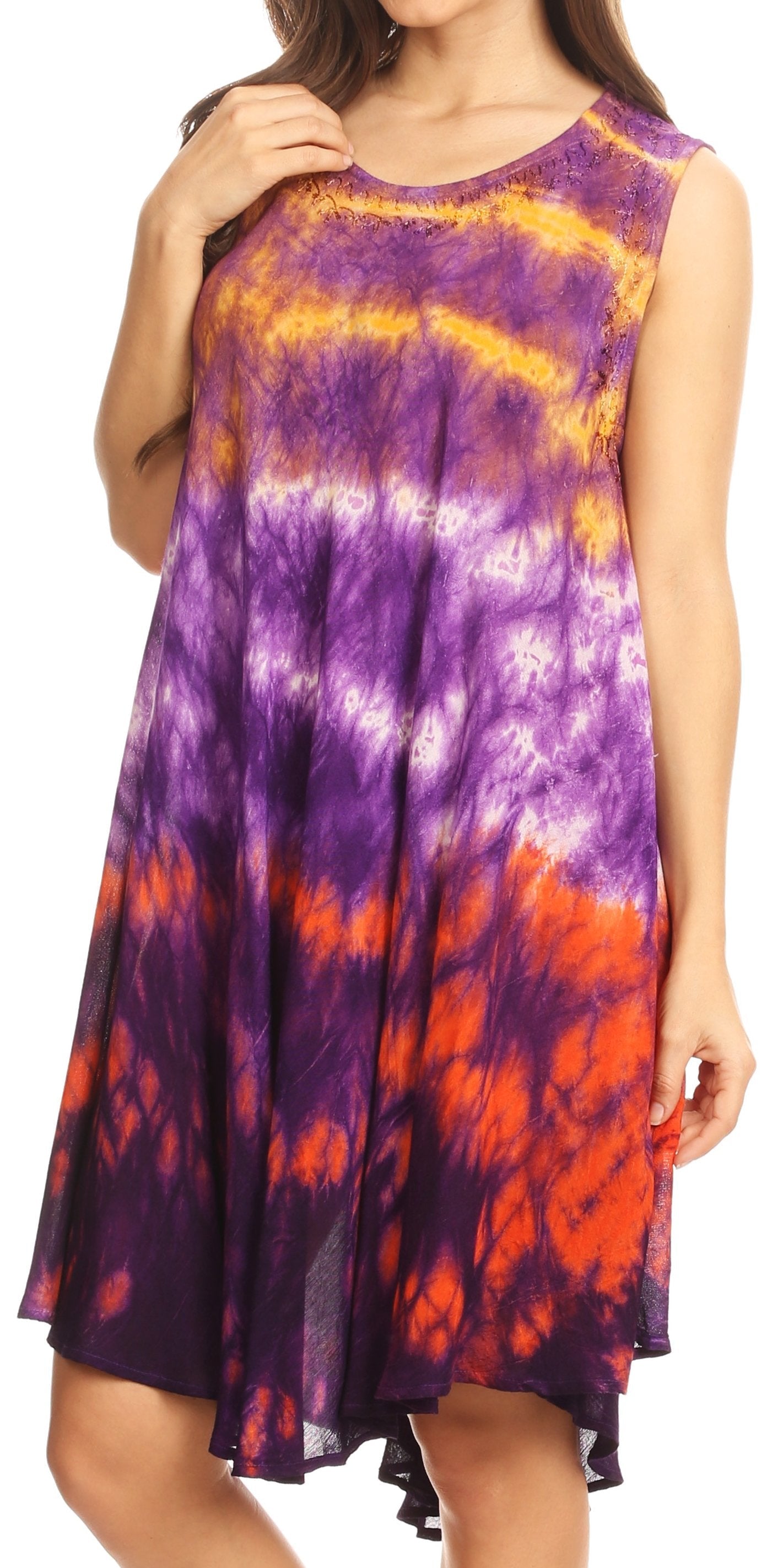 Woman wearing a tie-dye dress with purple, orange, and yellow colors.