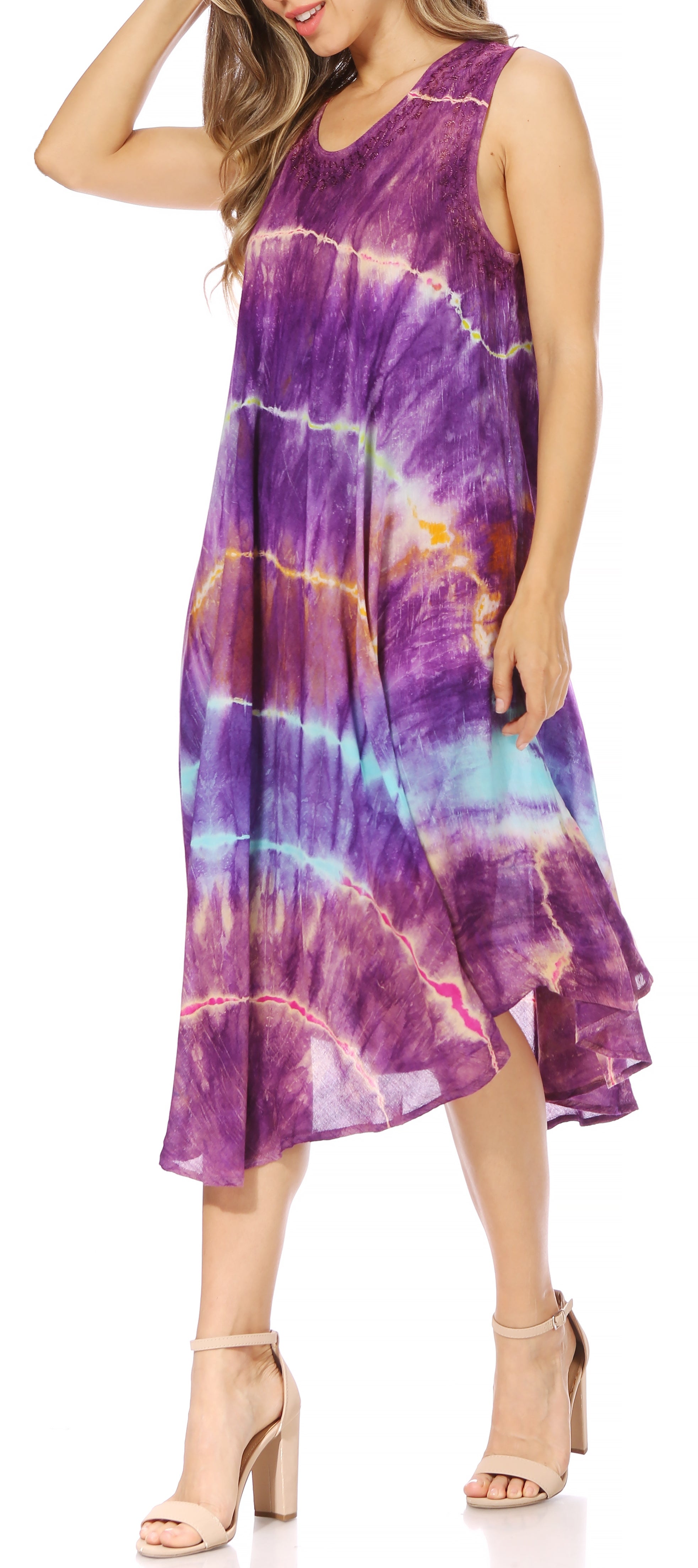 Woman wearing a tie-dye dress with a colorful pattern on a white background