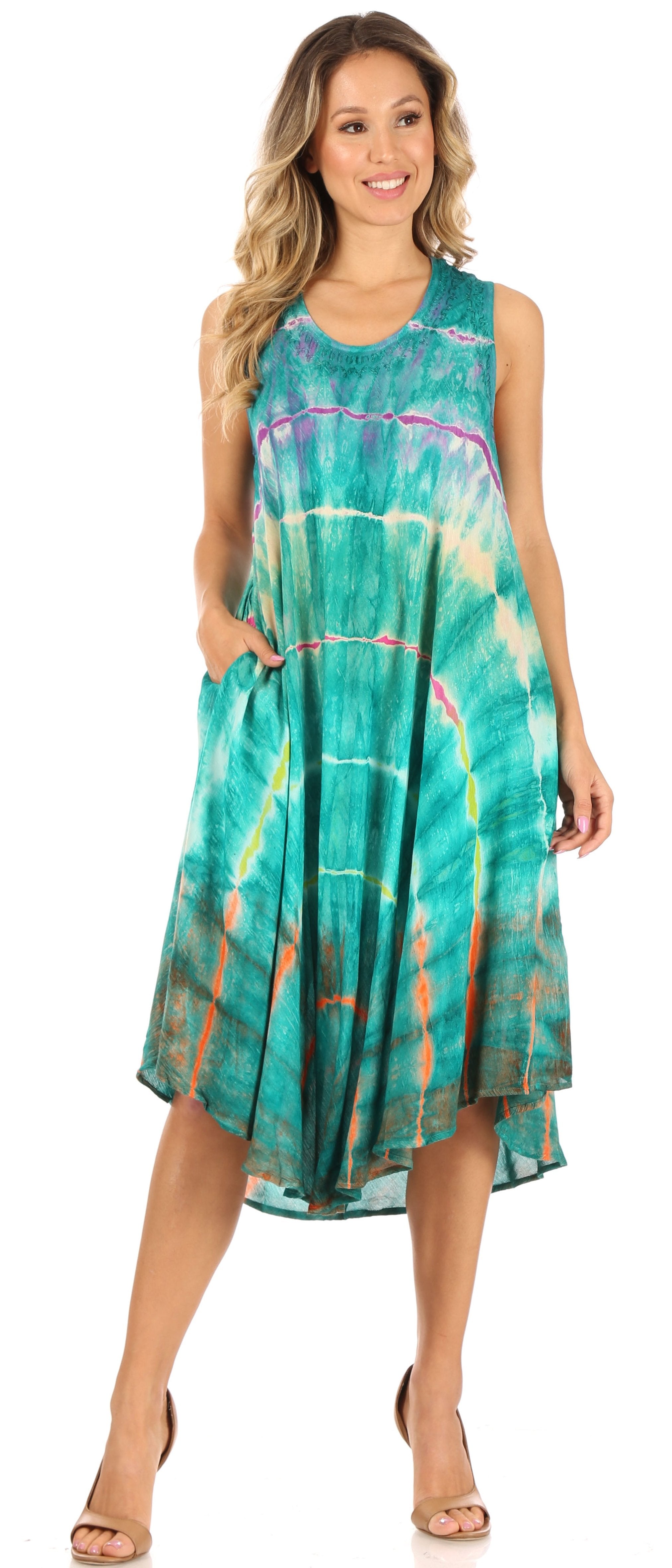 Woman wearing a sleeveless, tie-dye dress with a colorful pattern on a white background