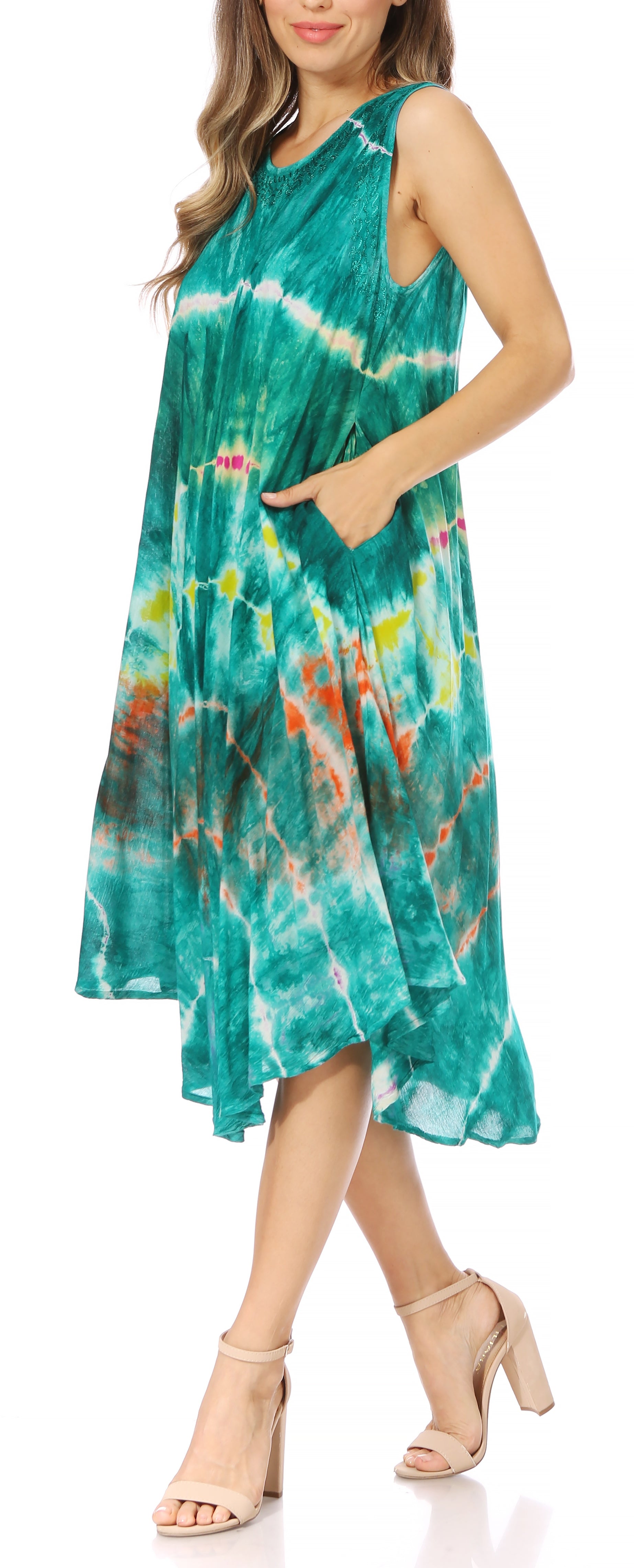 Woman wearing a tie-dye dress with a colorful pattern on a white background