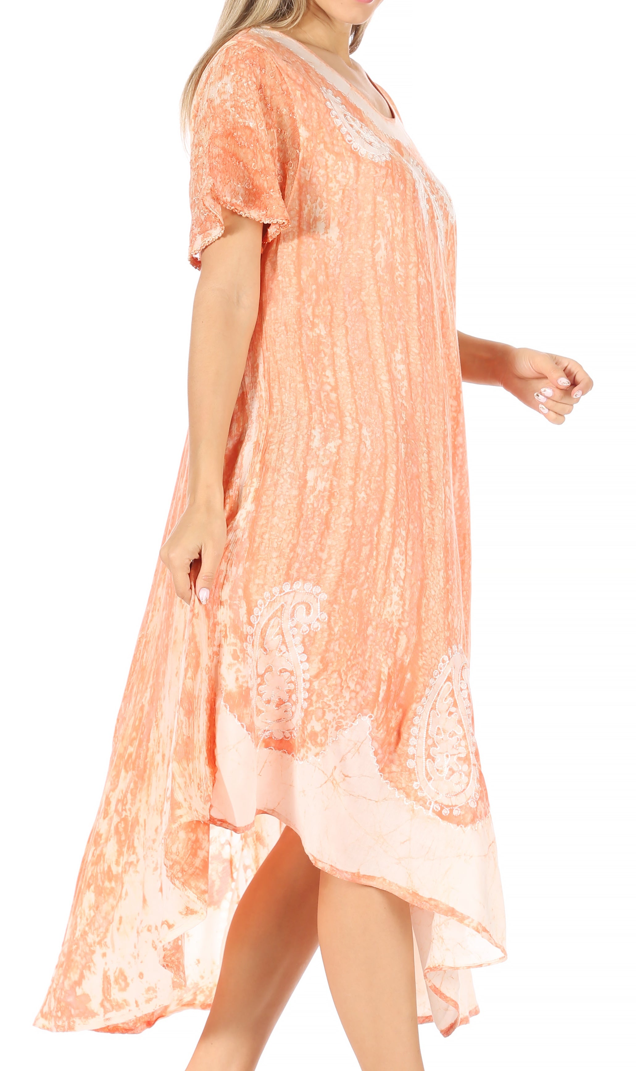 Woman wearing a peach-colored lace dress on a white background
