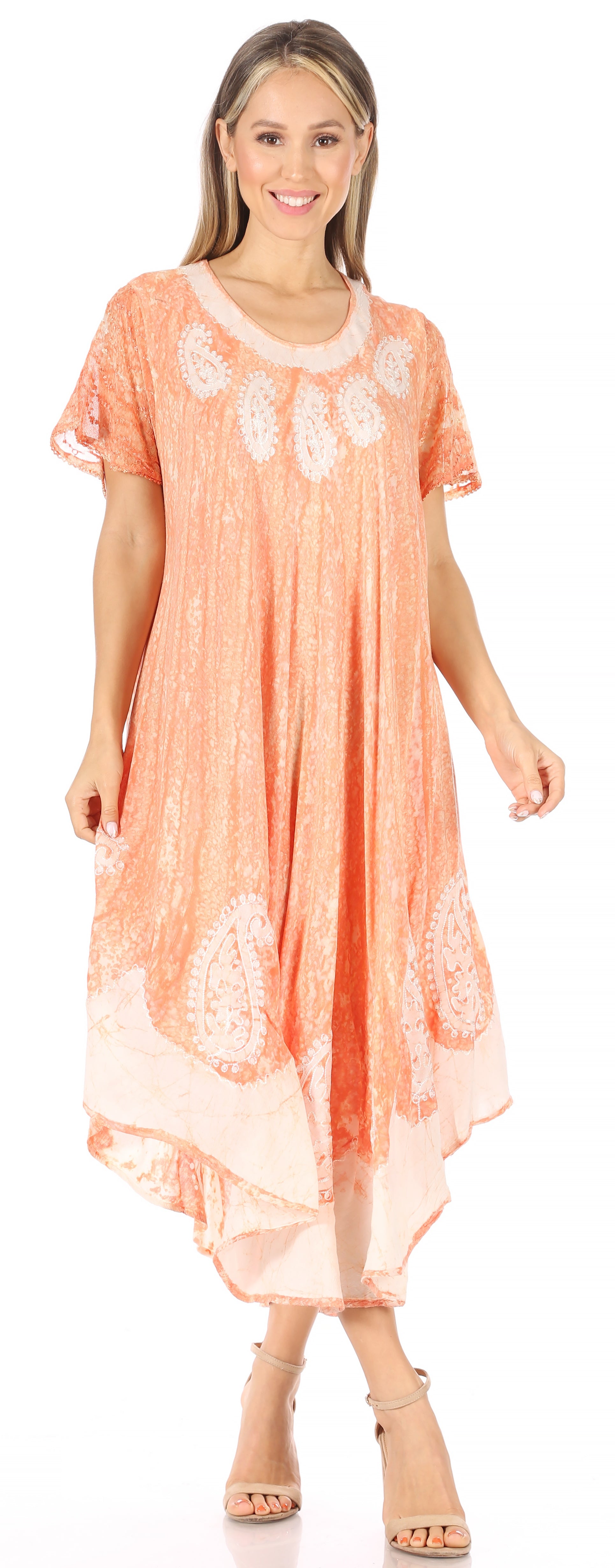 Woman wearing a peach-colored dress with lace details on a white background