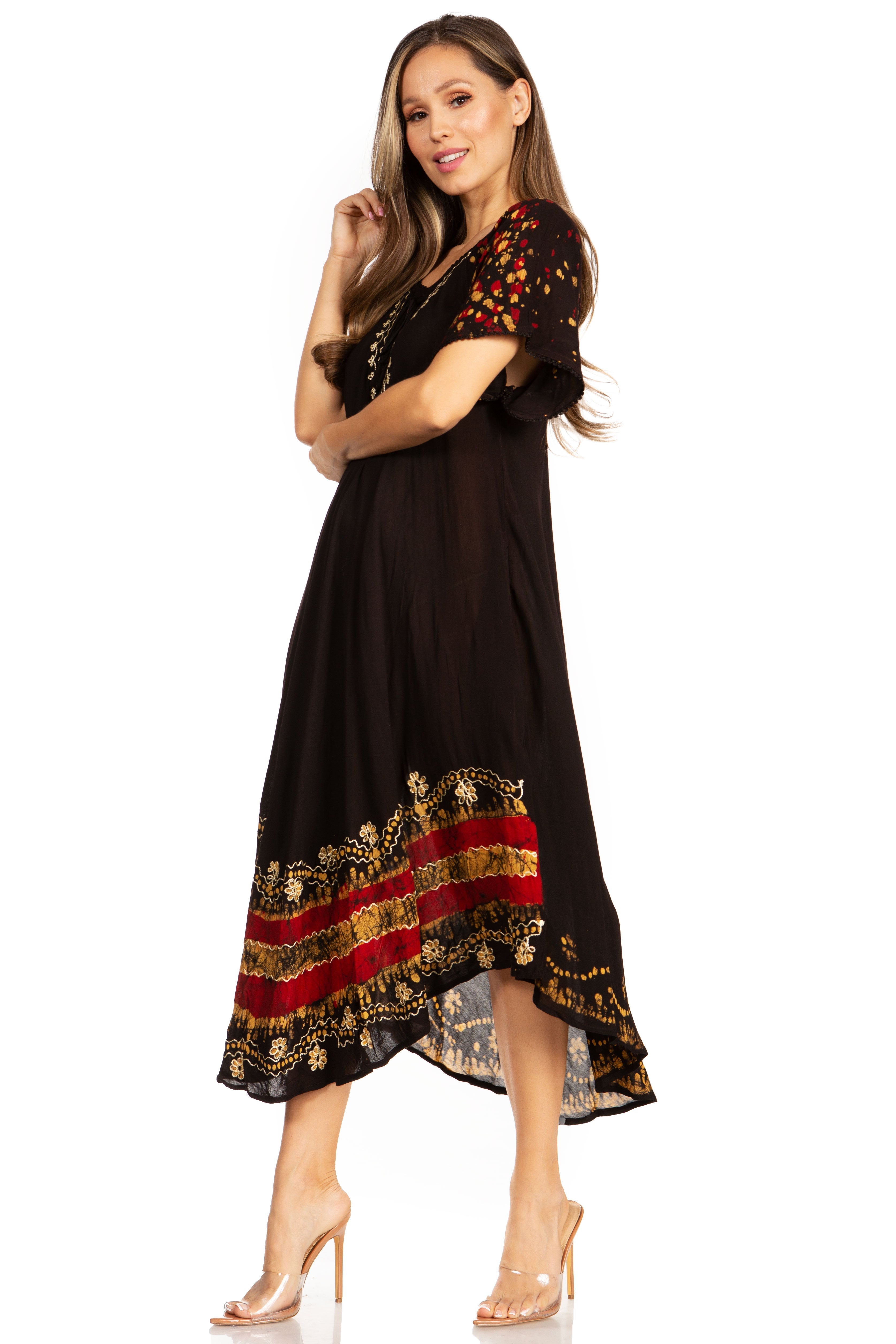 Woman wearing a black dress with red and gold patterns on a white background