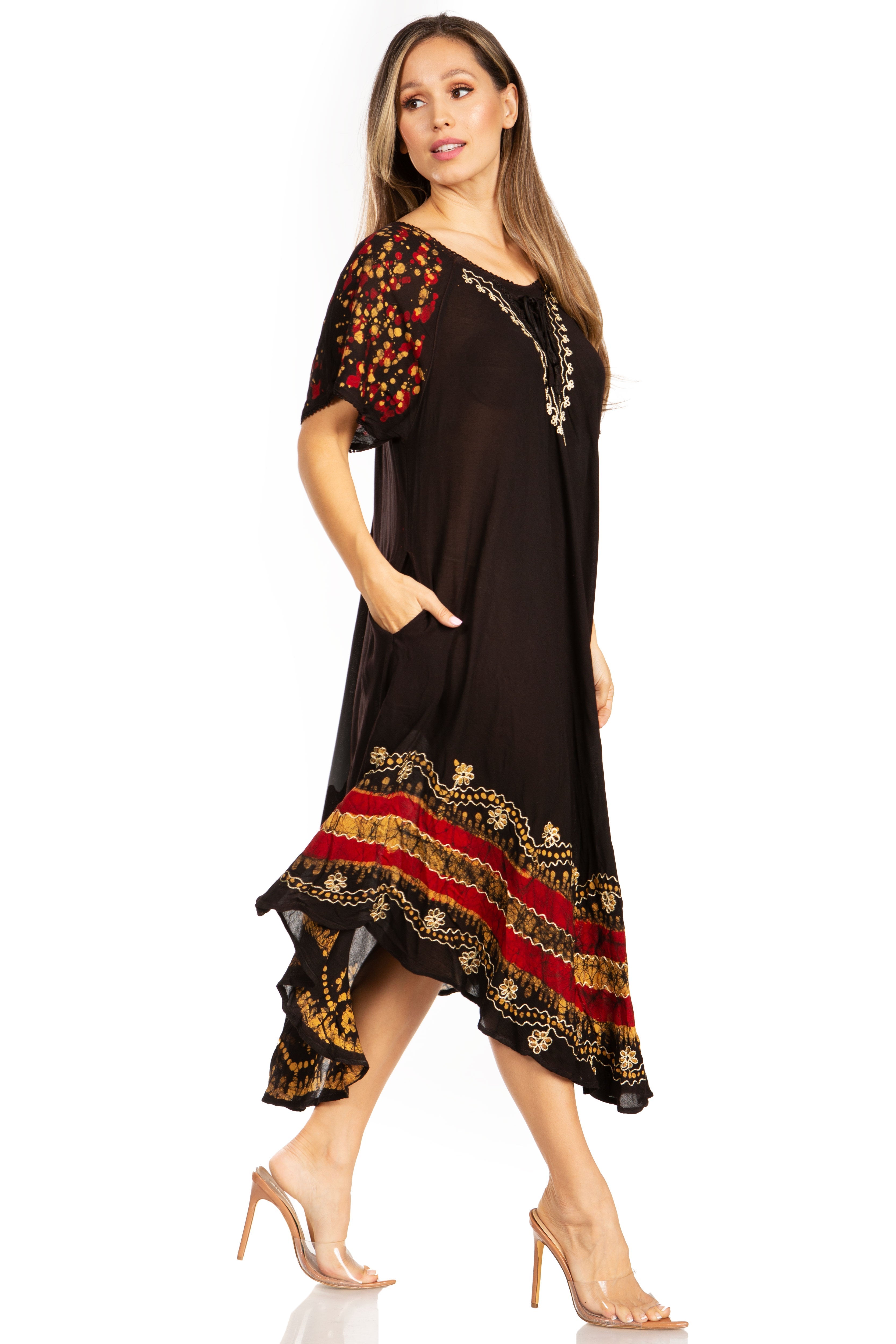 Woman wearing a black dress with red and gold embroidery on a white background