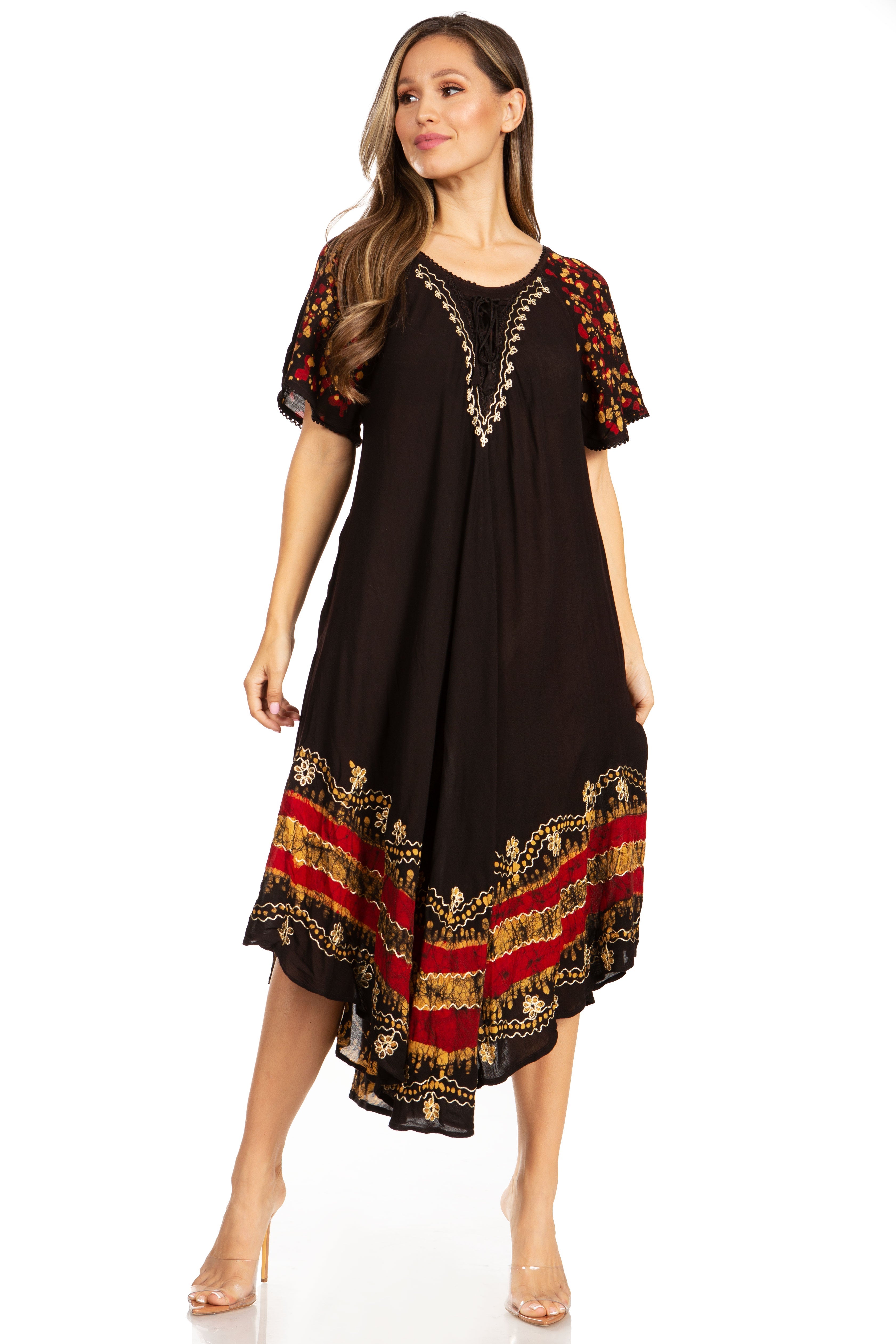 Woman wearing a black dress with red and gold patterns on a white background