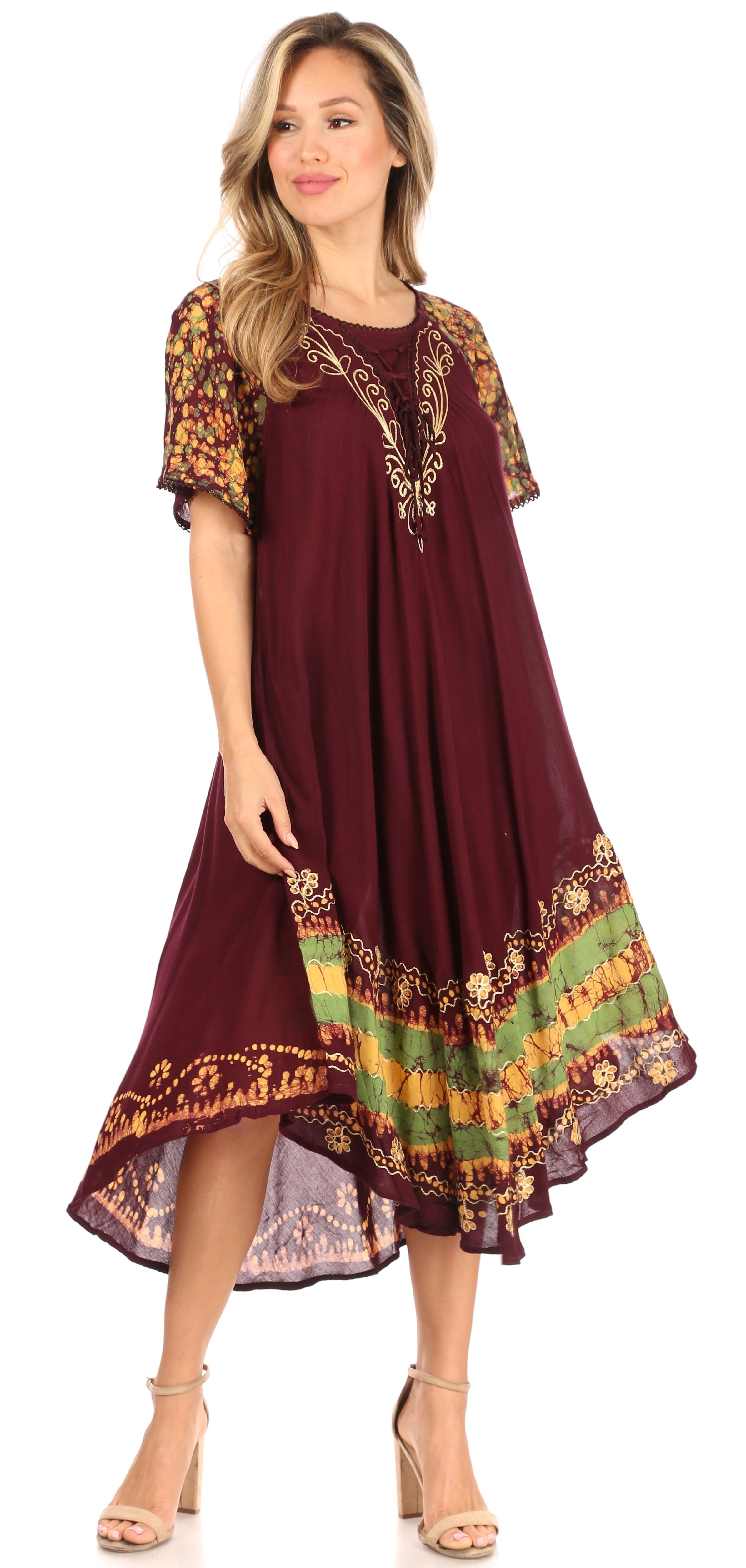 Woman wearing a burgundy dress with colorful embroidery on a white background