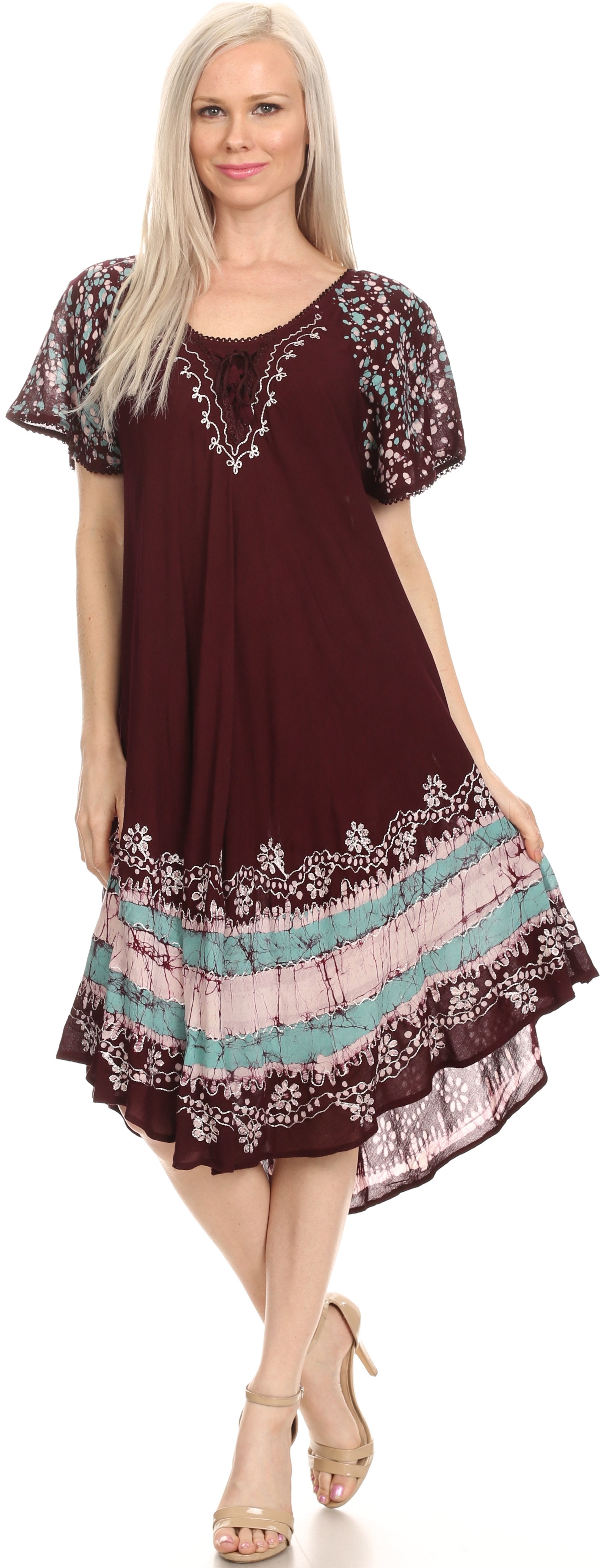 Woman wearing a burgundy dress with floral embroidery on a white background