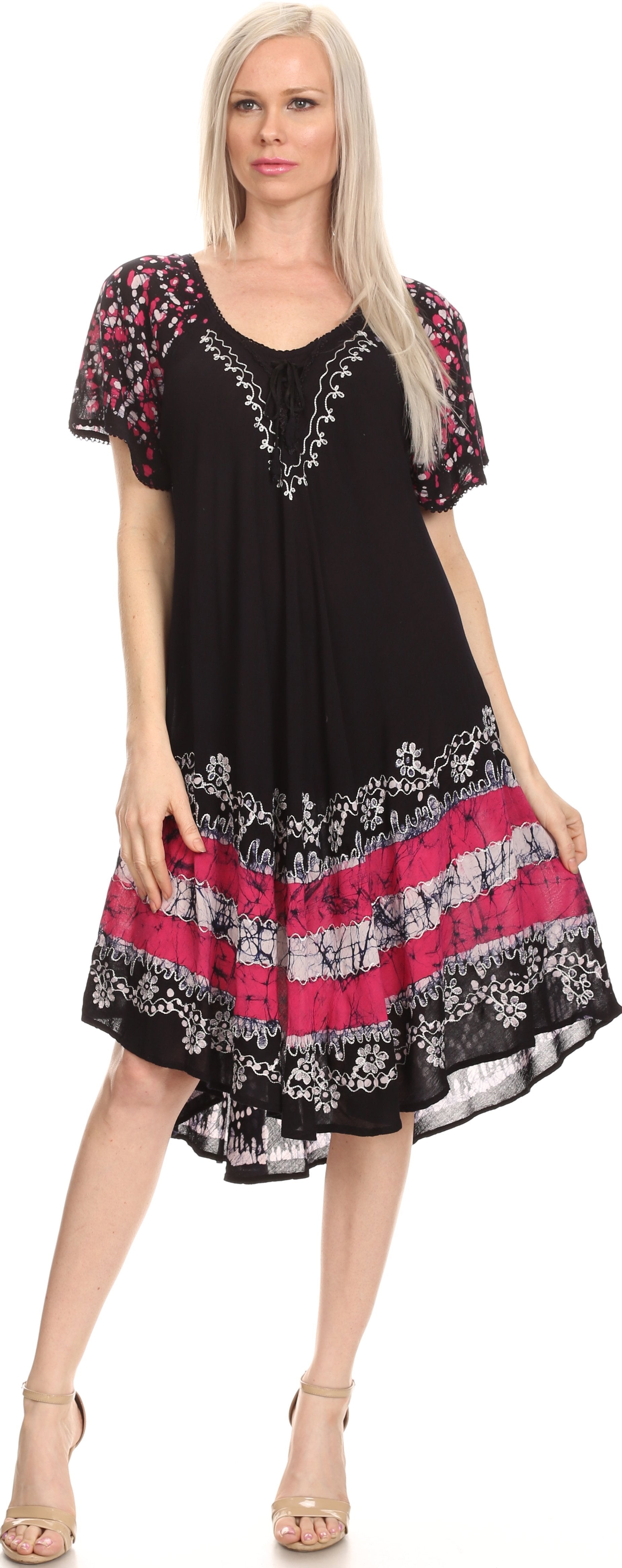 Woman wearing a black dress with floral patterns on a white background